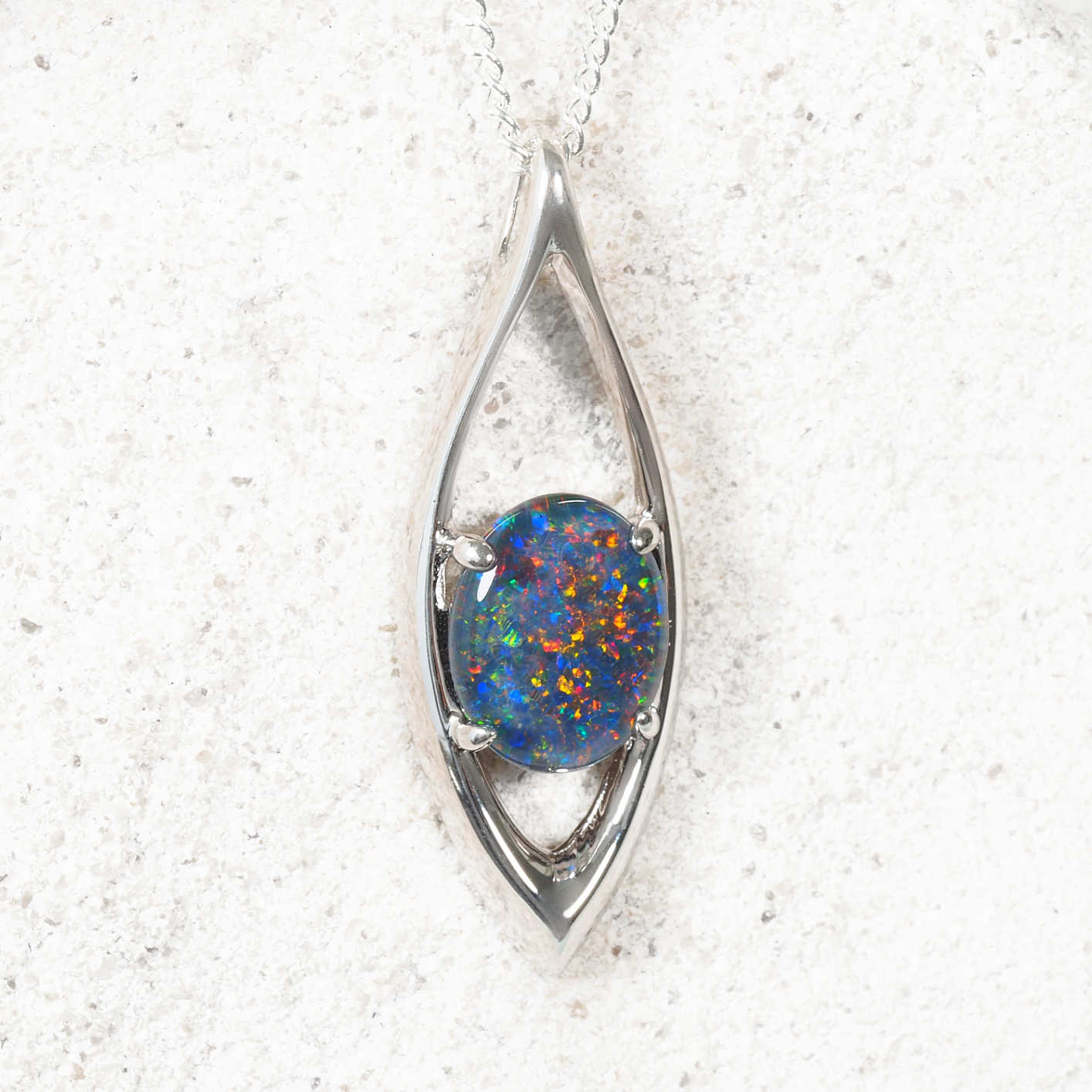 Opal pendant in a silver setting on a white background