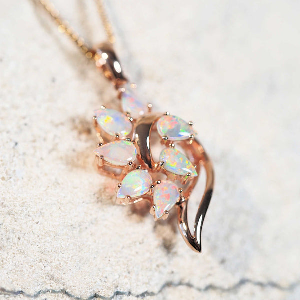 rose gold opal jewellery piece set in a 14ct gold pendant with seven stones