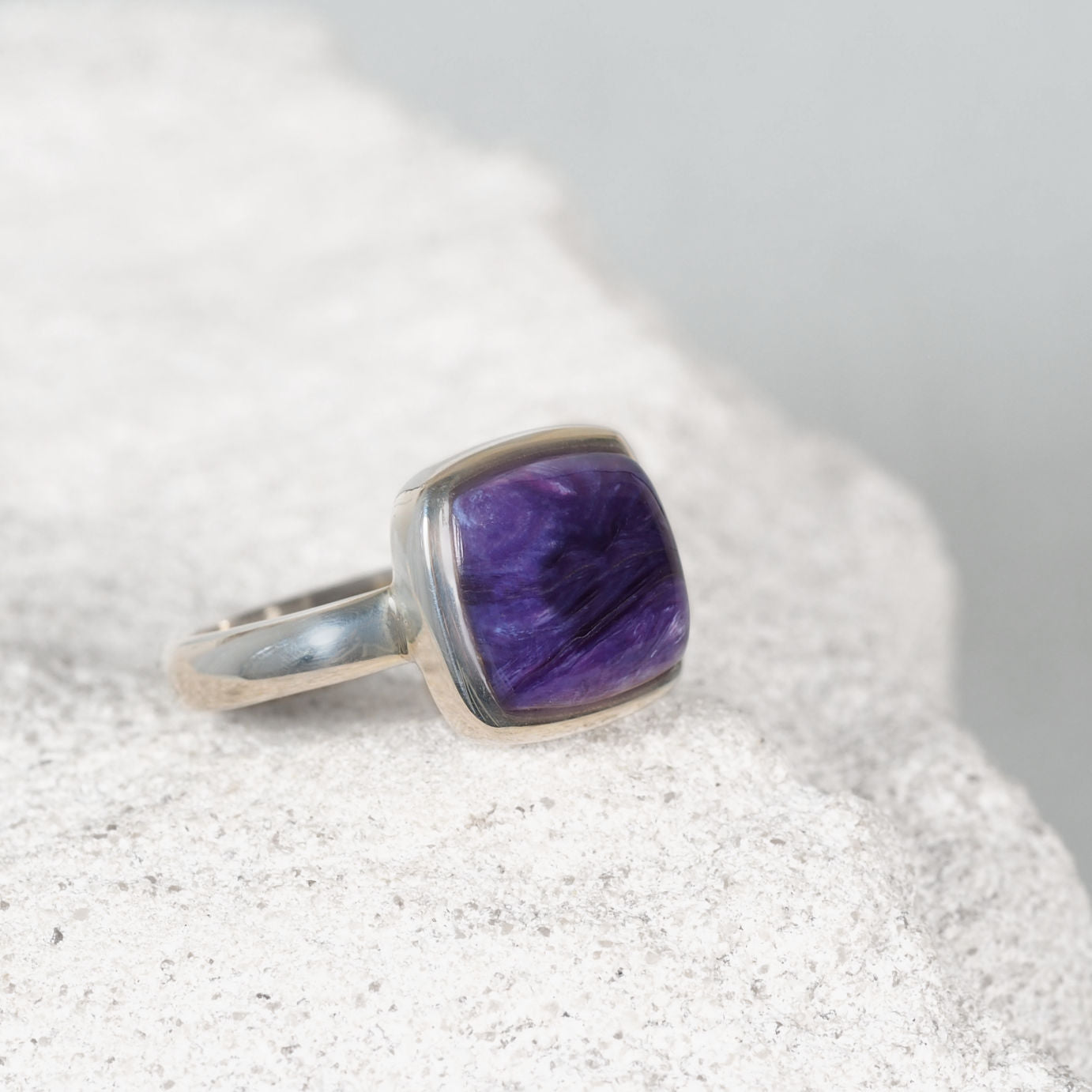 Elegant silver ring featuring a small square Charoite cabochon with soft purple and white tones