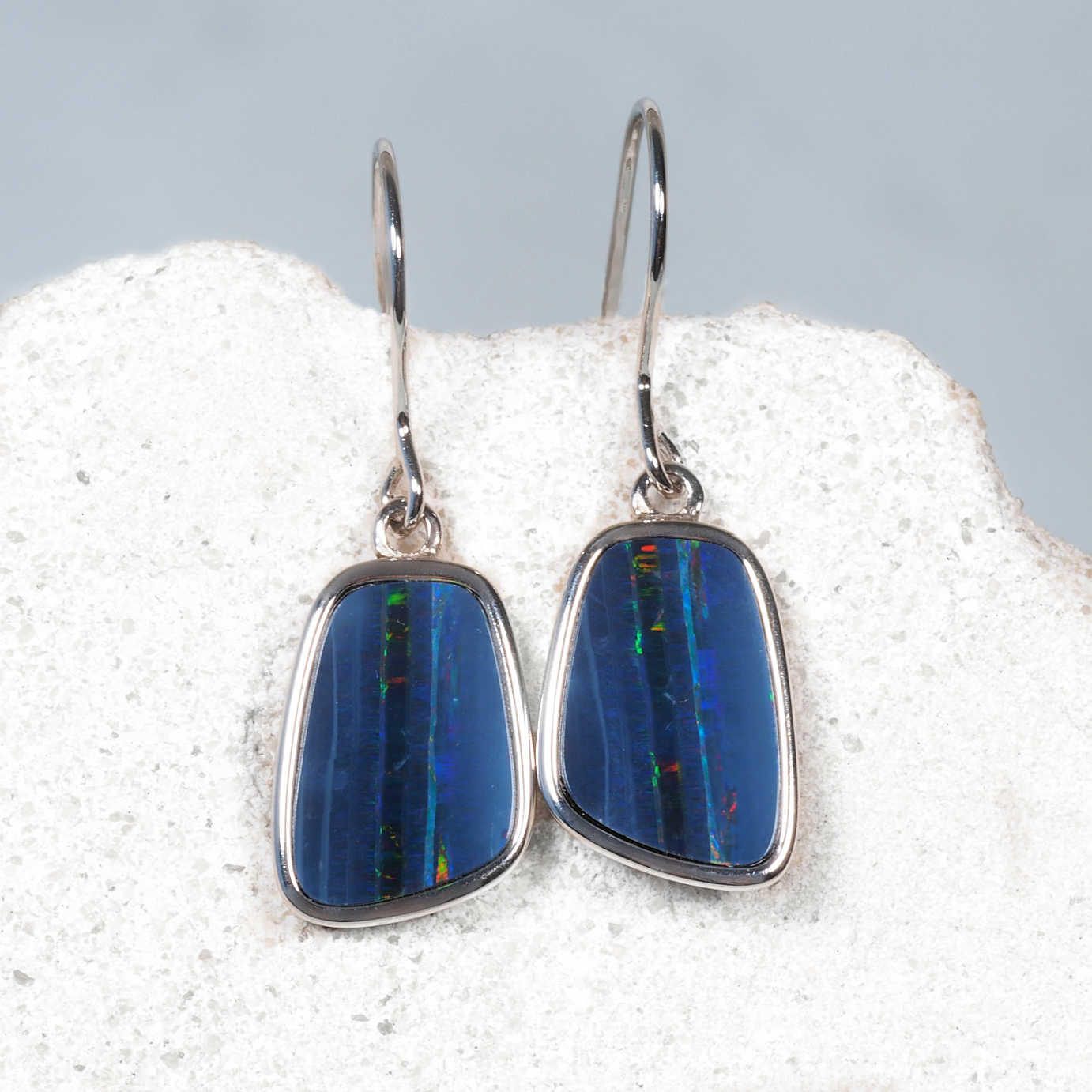 Sterling silver drop earrings with doublet opals showing green and red flashes.