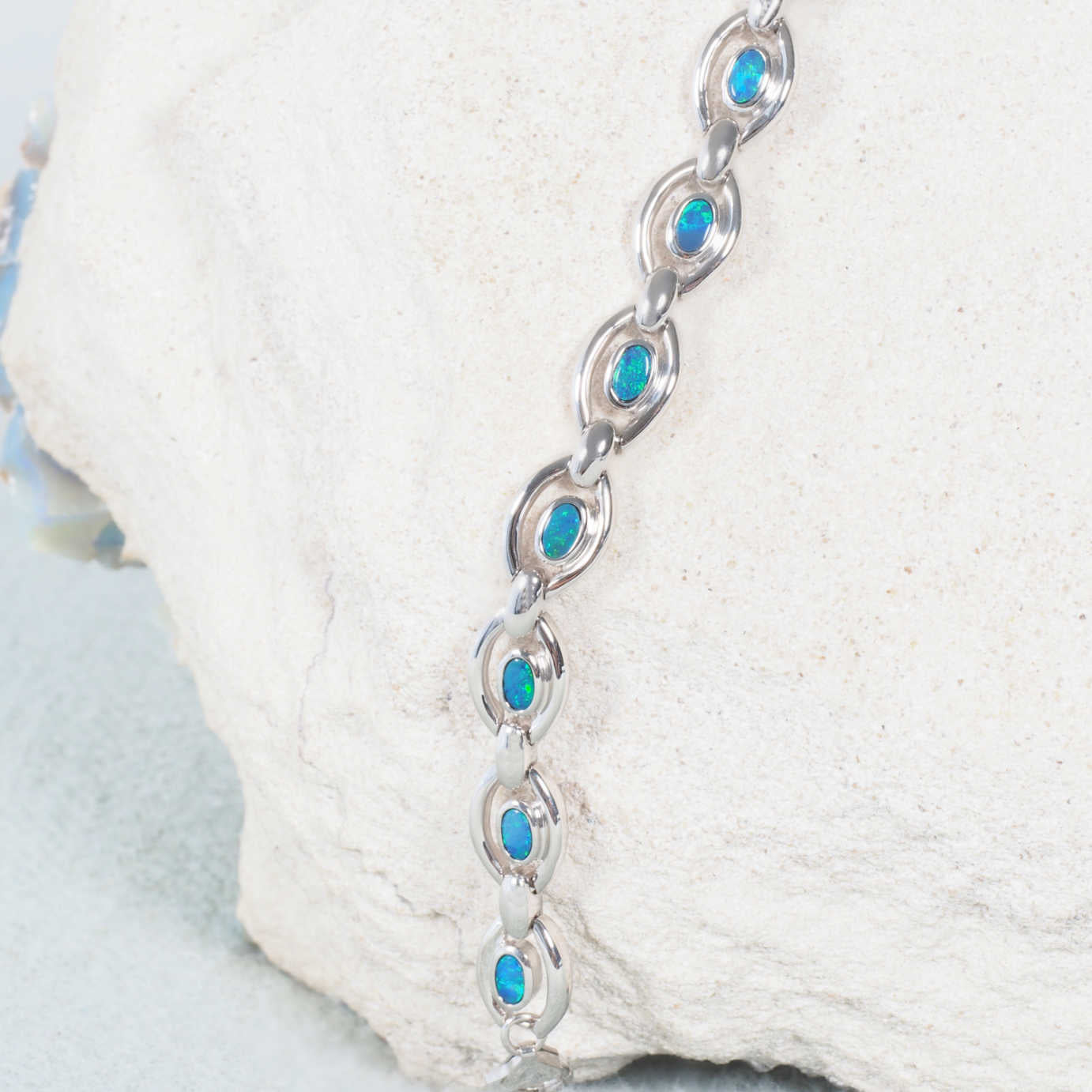 Contemporary silver opal bracelet with multiple bezel set oval-shaped opals