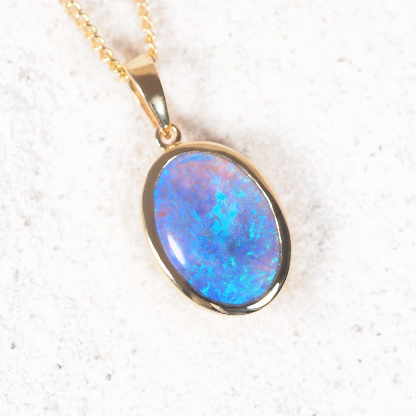 Handcrafted 18ct gold bezel-set crystal opal pendant with vivid play-of-colour