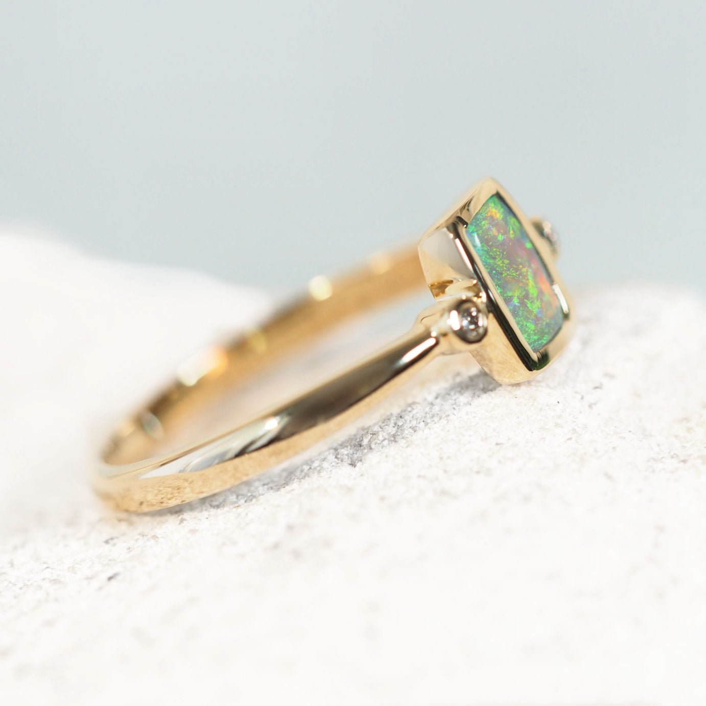 Luxury gold opal ring with vibrant green Lightning Ridge opal and white diamond accents