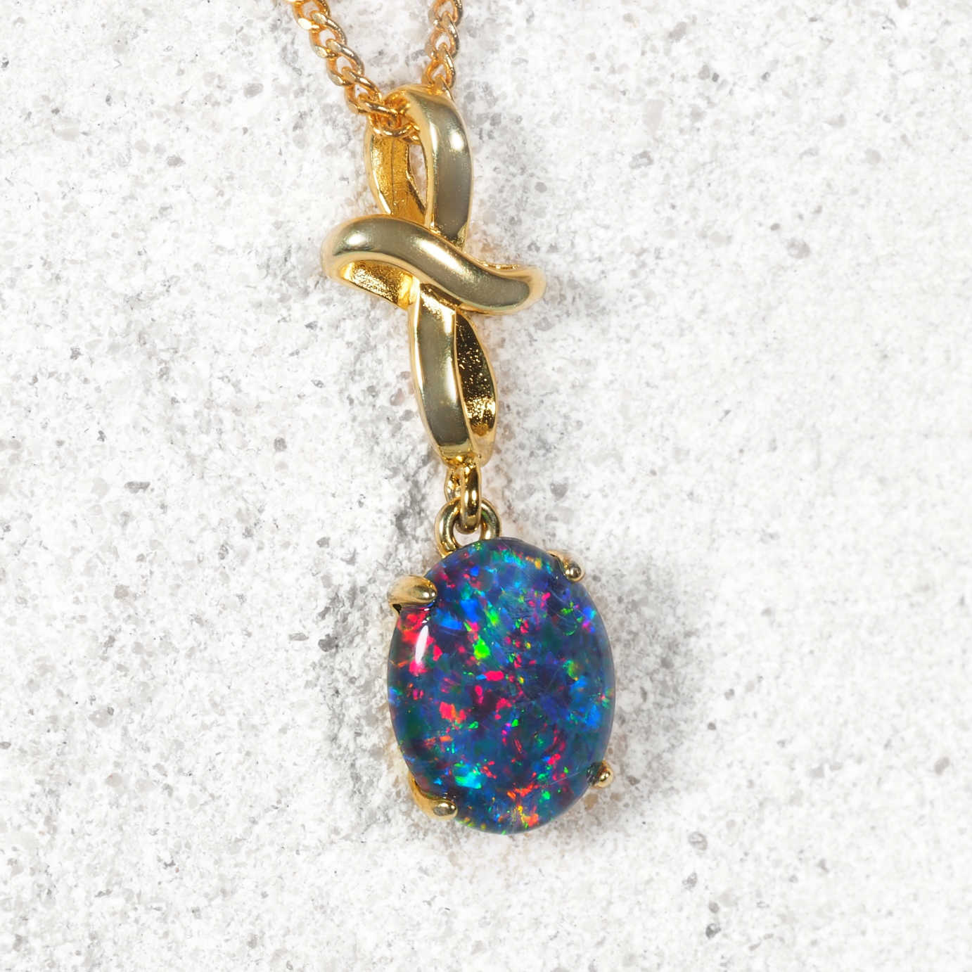‘Nicci’ gold plated opal pendant with curved cross design and multi-colour Australian triplet opal
