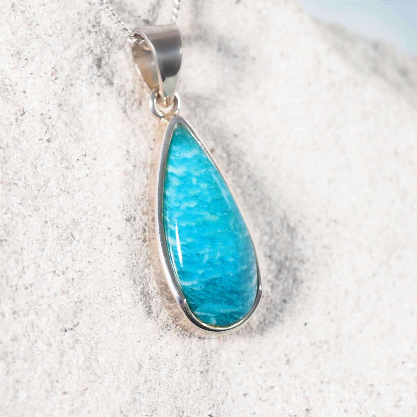 Close-up of The 'Nina' pendant highlighting Amazonite cabochon set in a sleek silver frame