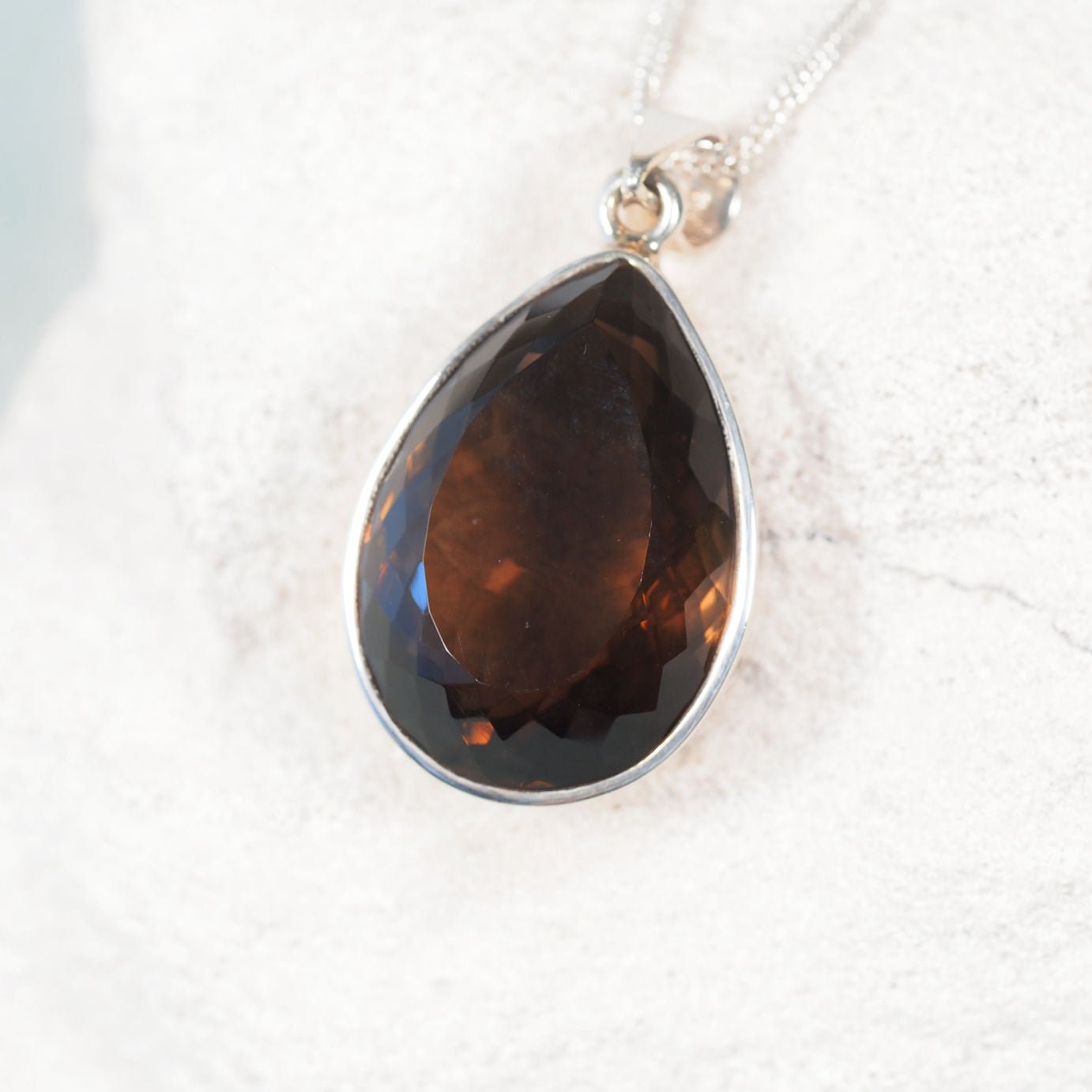 'Noemi' Smokey Quartz pendant featuring a sparkling teardrop gemstone in a sleek silver frame