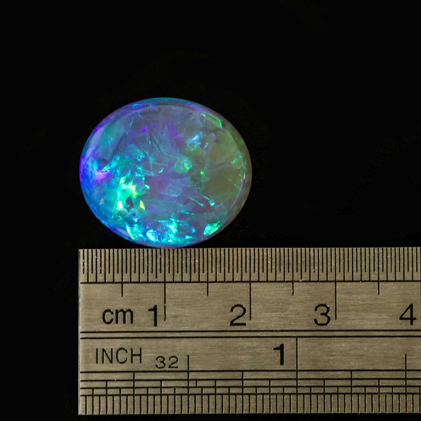 Close-up of blue and green flashes in a high-quality crystal opal