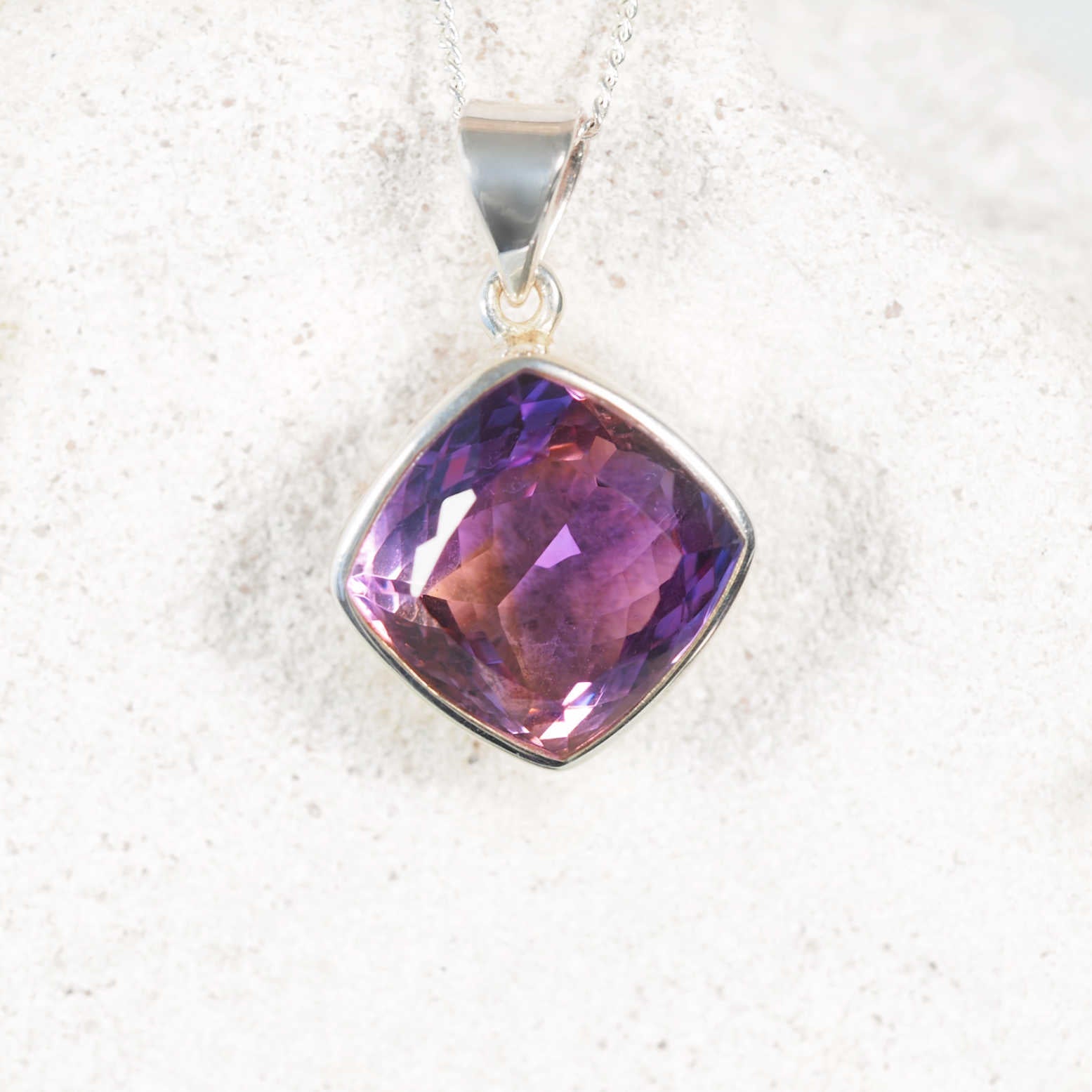 'Odelia' Amethyst pendant showcasing sparkling purple gemstone in polished silver frame