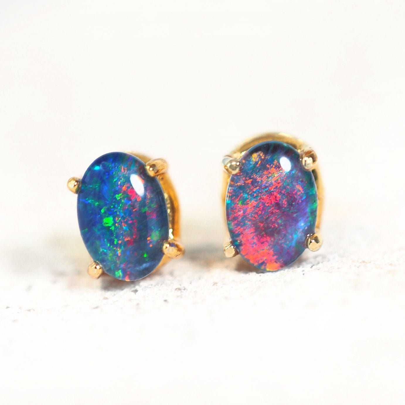 oval opal earrings set in gold plated silver with colourful opal stones