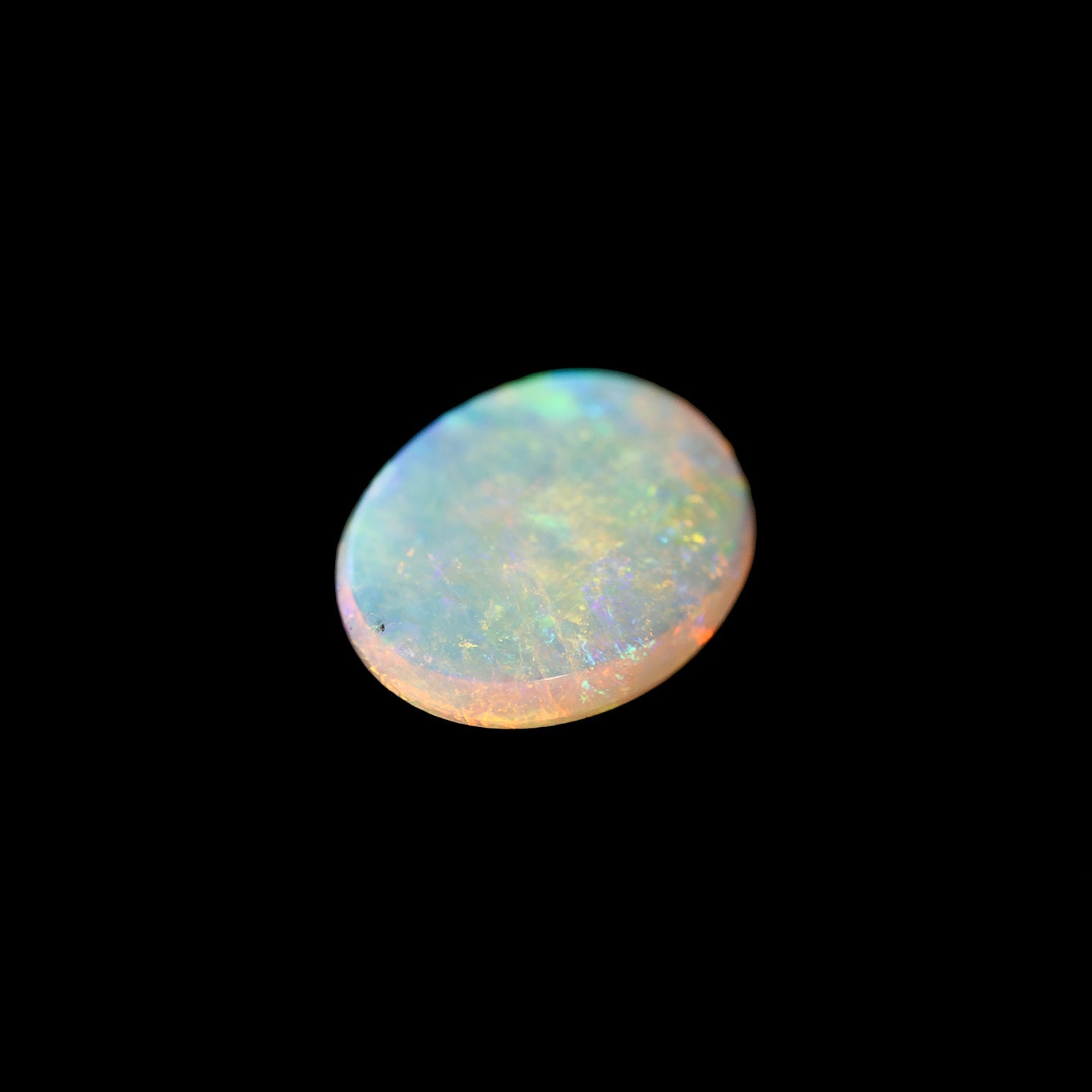 Solid opal stone on a black background