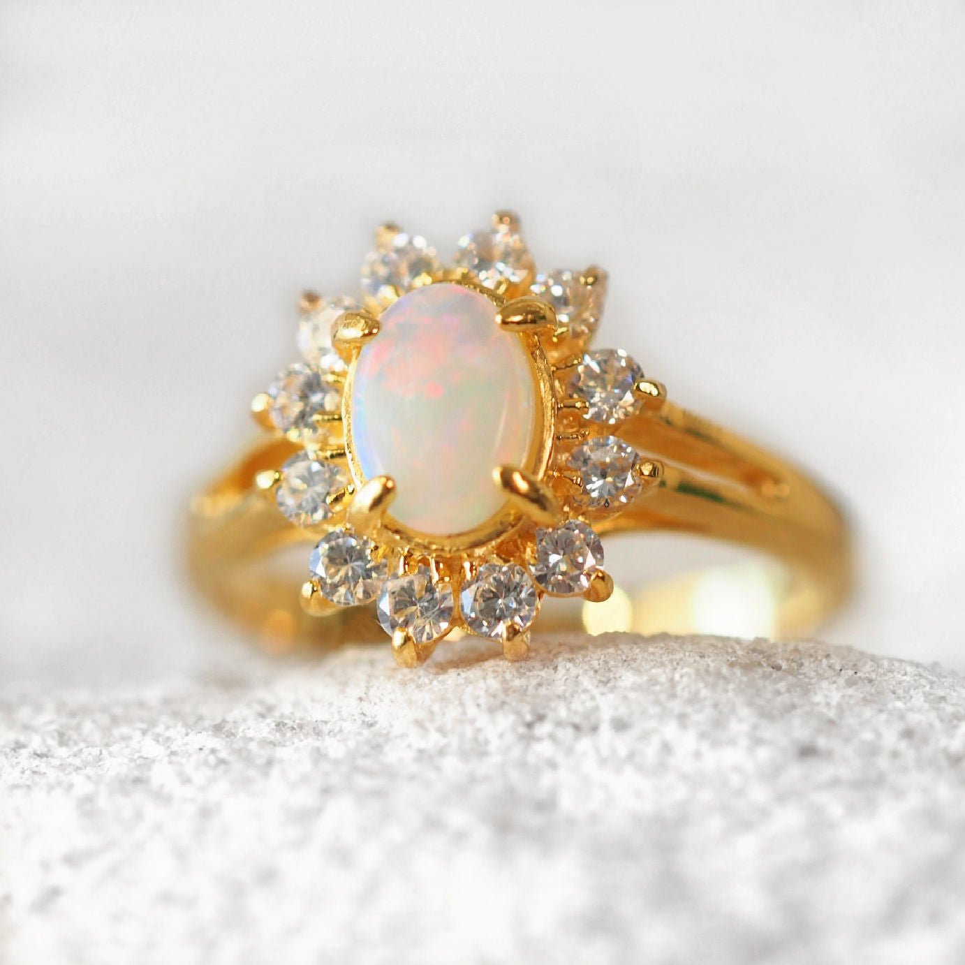 Solid opal ring in gold plated silver with diamante halo