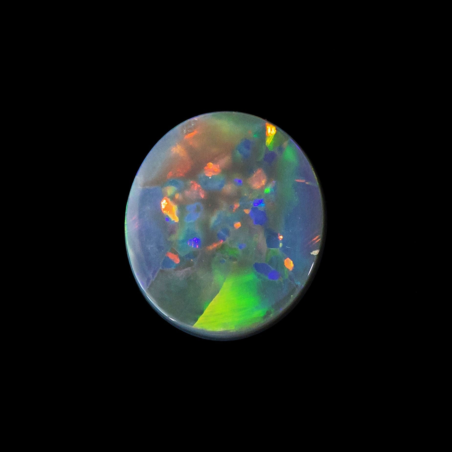 Round-oval Rainbow Star opal with rolling broad flash pattern and vivid colour play