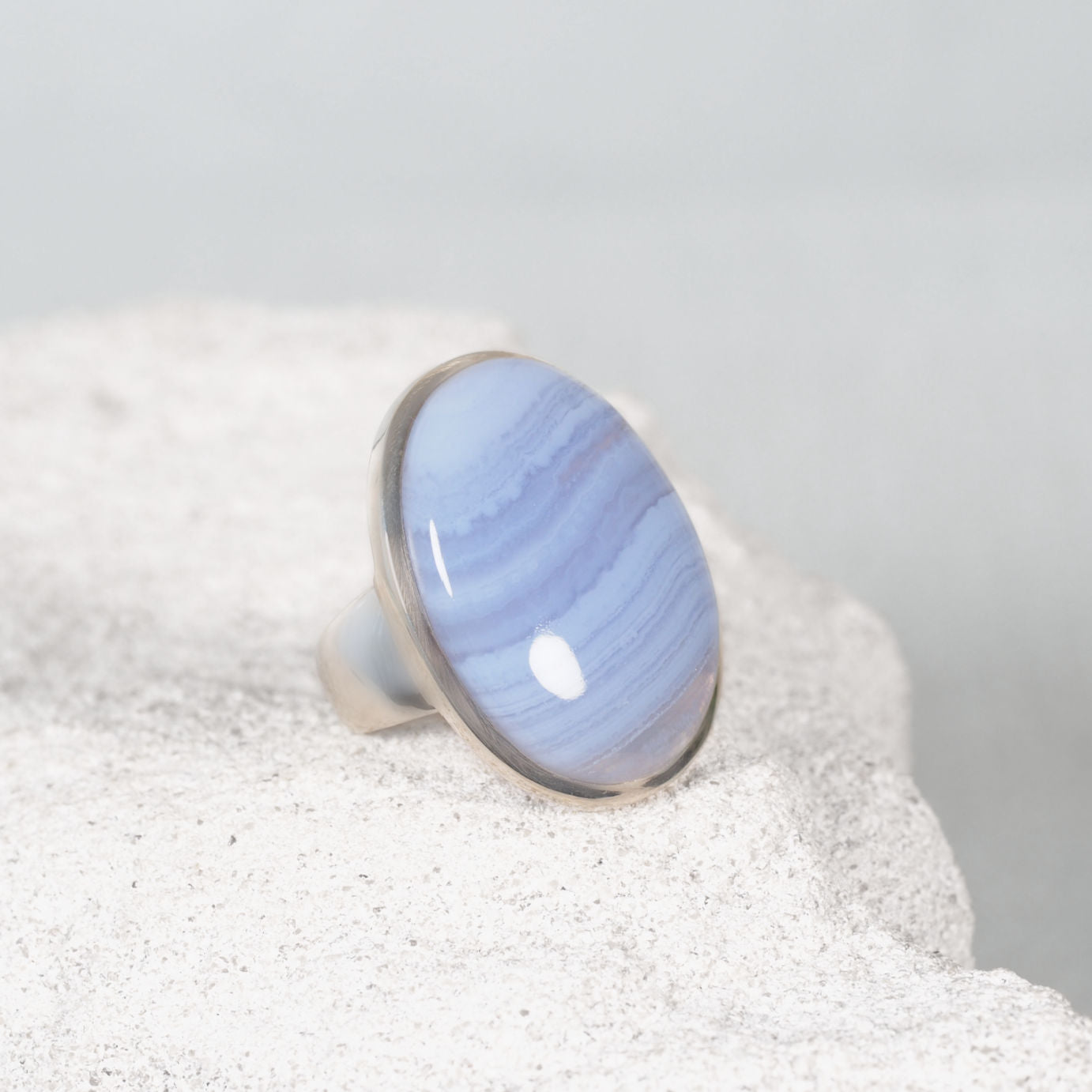 Gemstone Ring displayed on a sandy background displaying blue colour gem