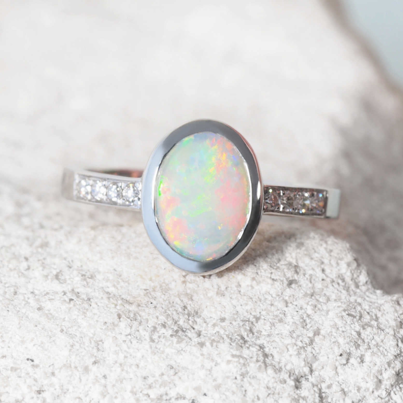 Close-up of Selene ring featuring oval-shaped crystal opal
