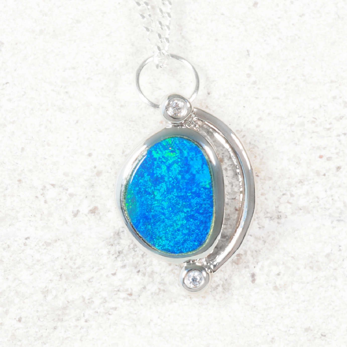Doublet opal pendant set in silver with a chain