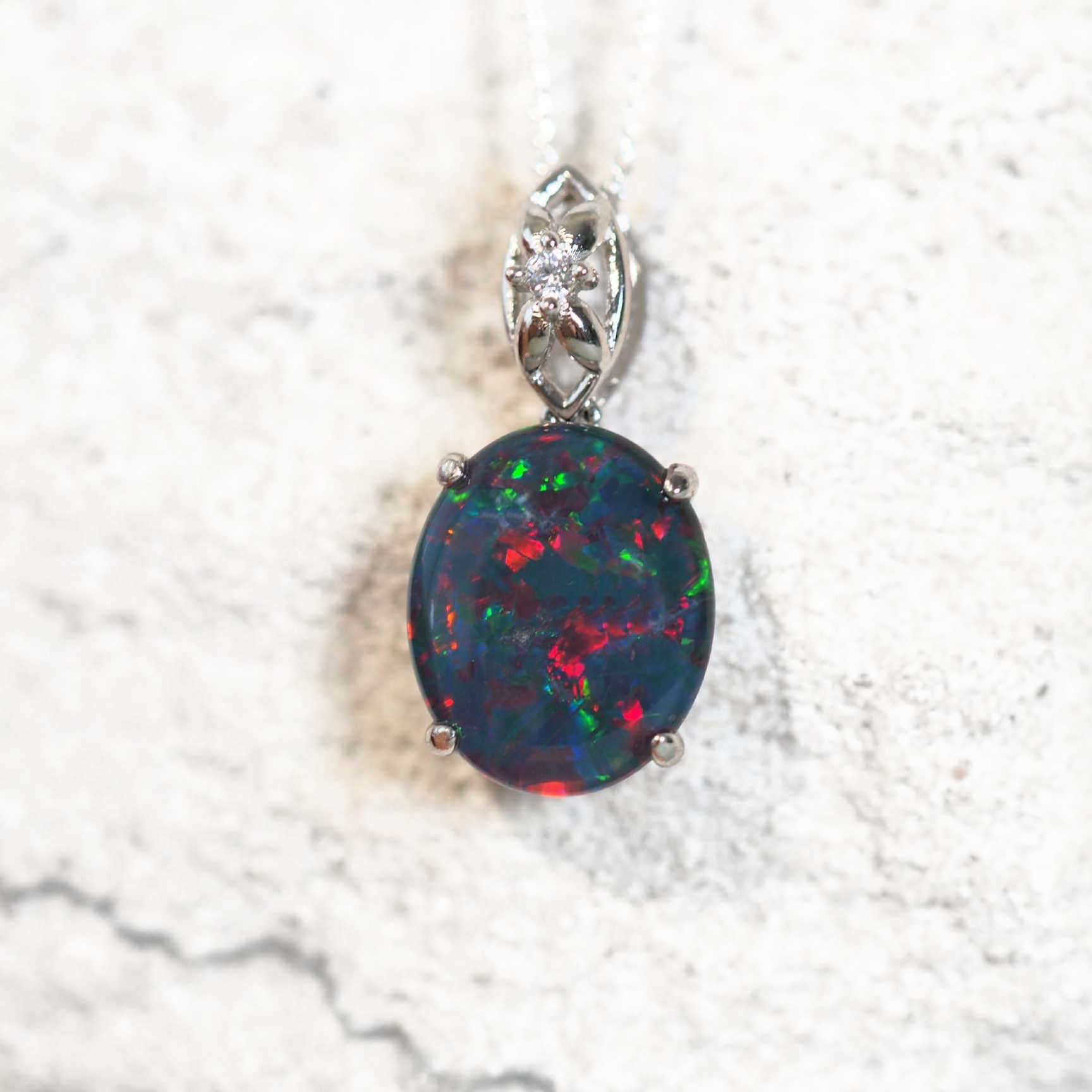 large opal pendant set in sterling silver with a cubic zirconia