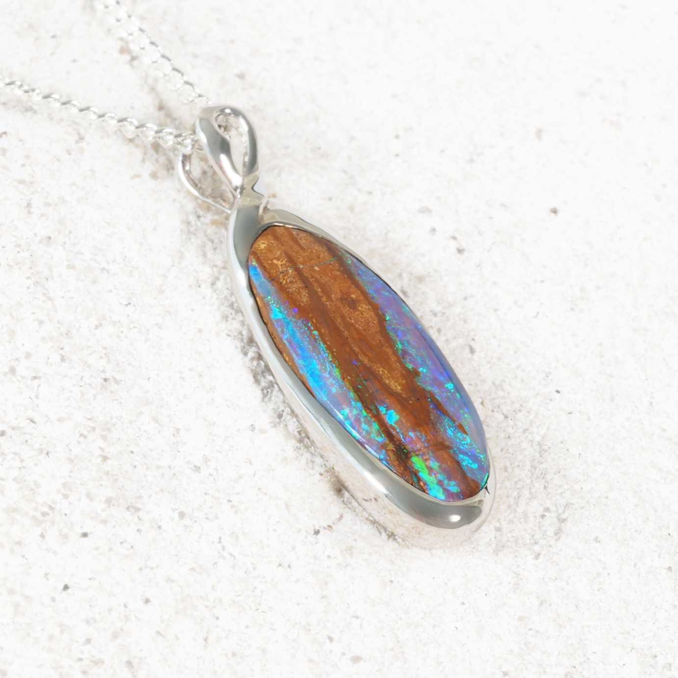 Elegant silver opal pendant with glowing Queensland boulder opal
