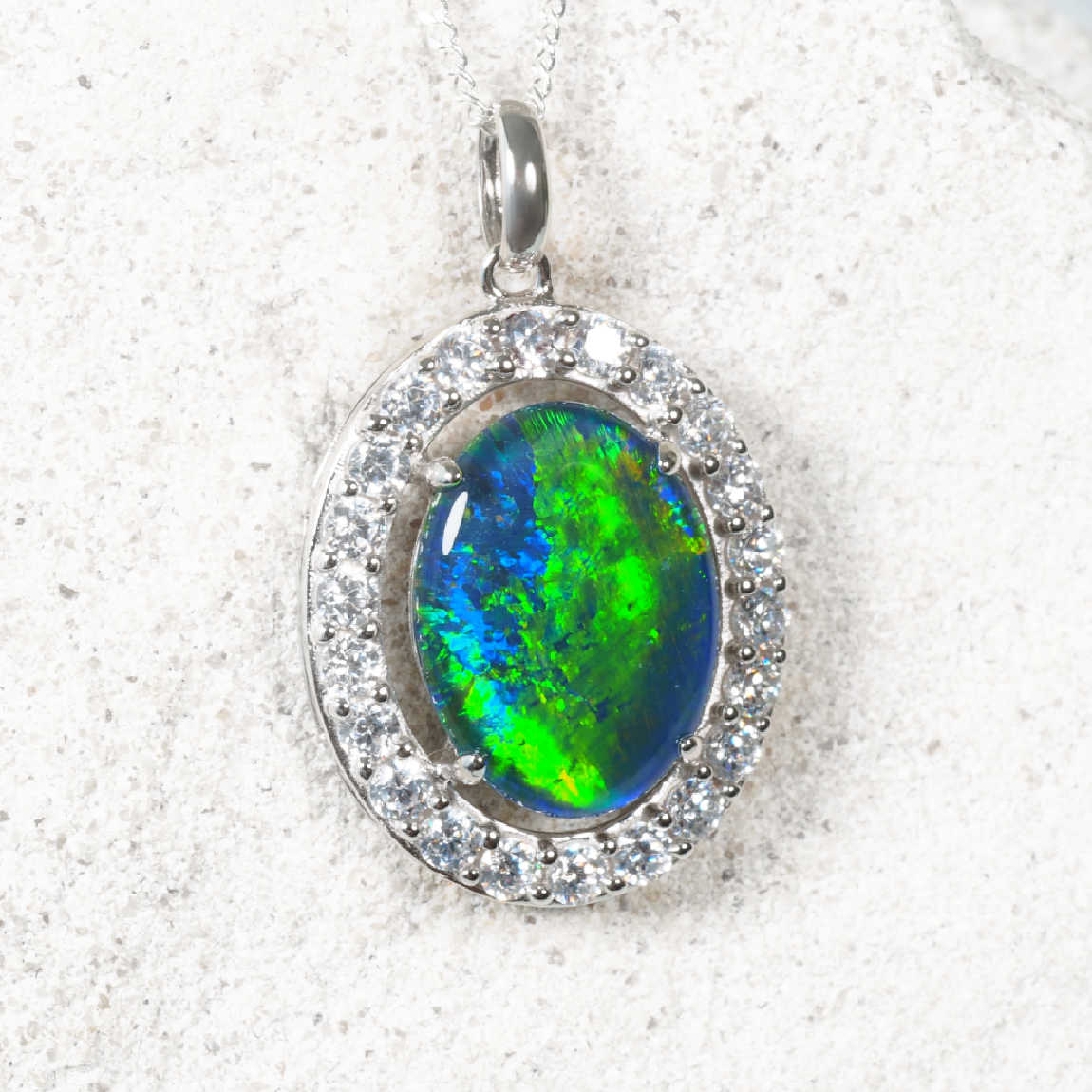 ‘Stella’ sterling silver opal pendant with oval blue-green Australian triplet opal surrounded by cubic zirconias