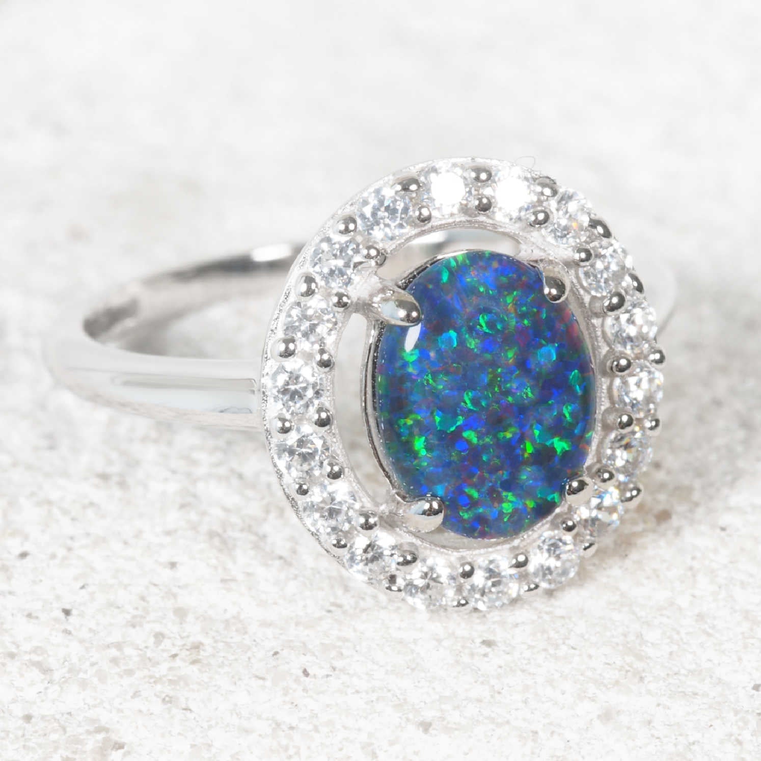 Blue opal ring set in sterling silver with a princess halo