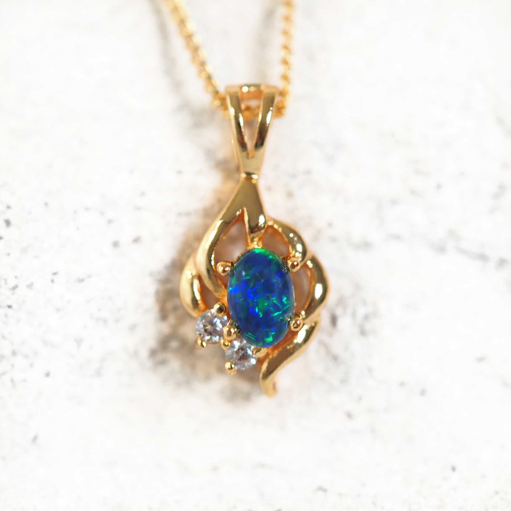 Gold-plated silver opal pendant necklace with blue-green Australian triplet opal and cubic zirconias on matching chain.