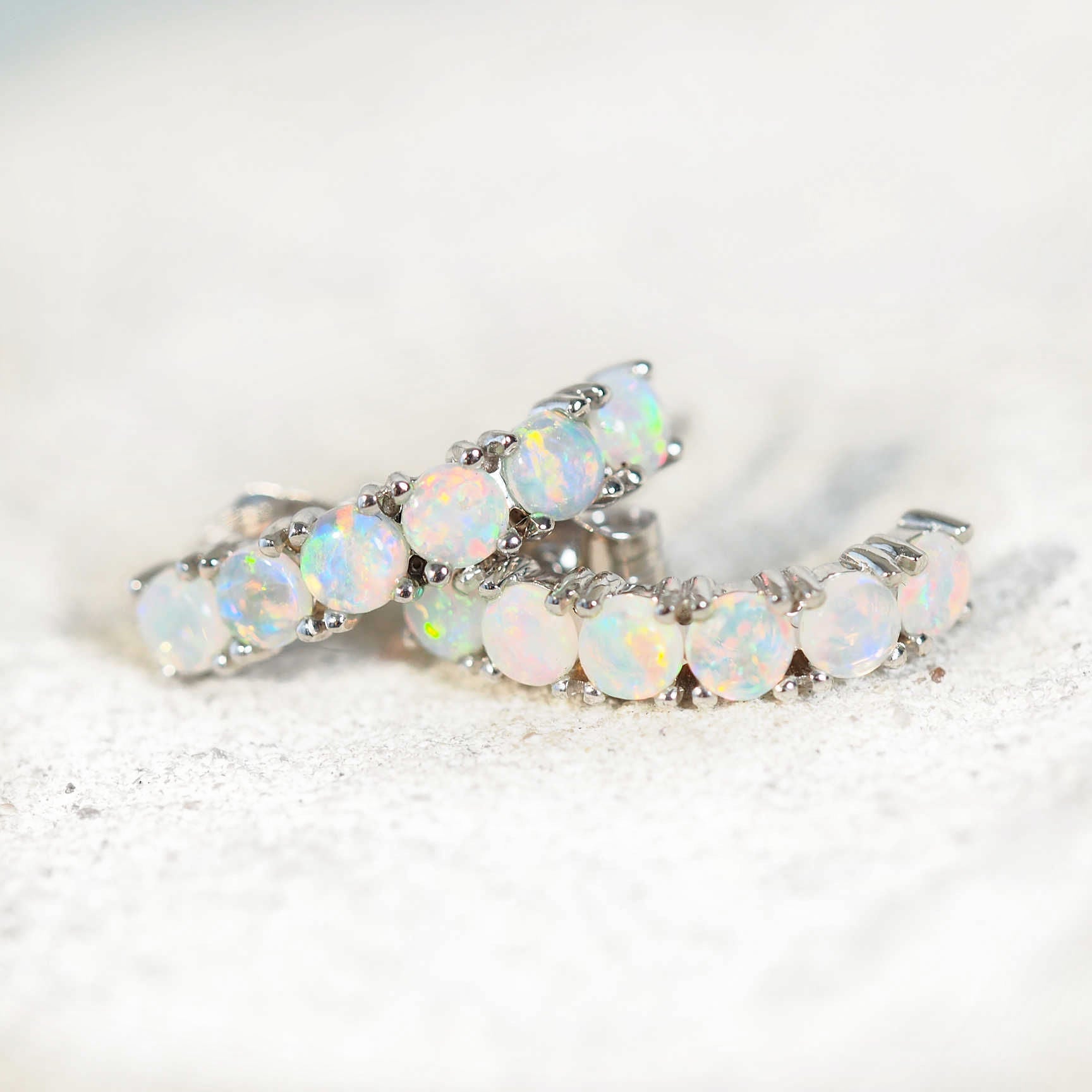 twelve opal earrings set in white gold