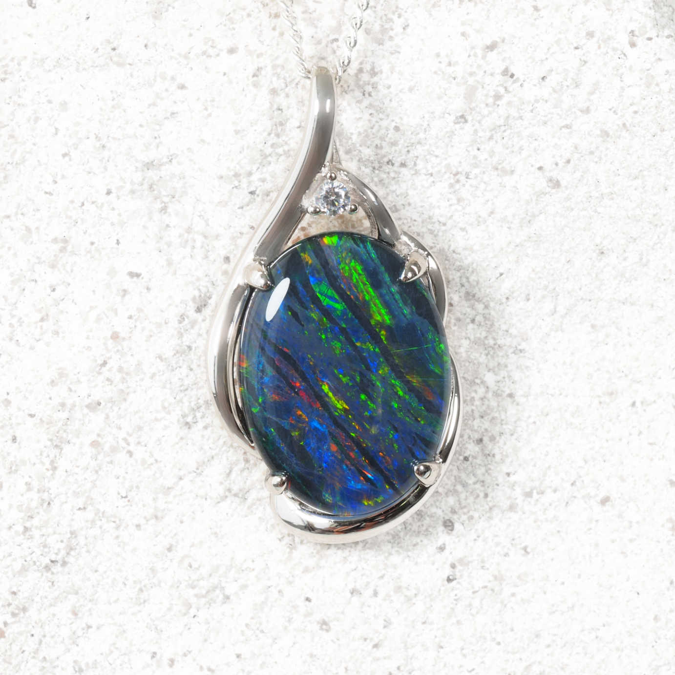 Opal pendant in a silver setting on a white background