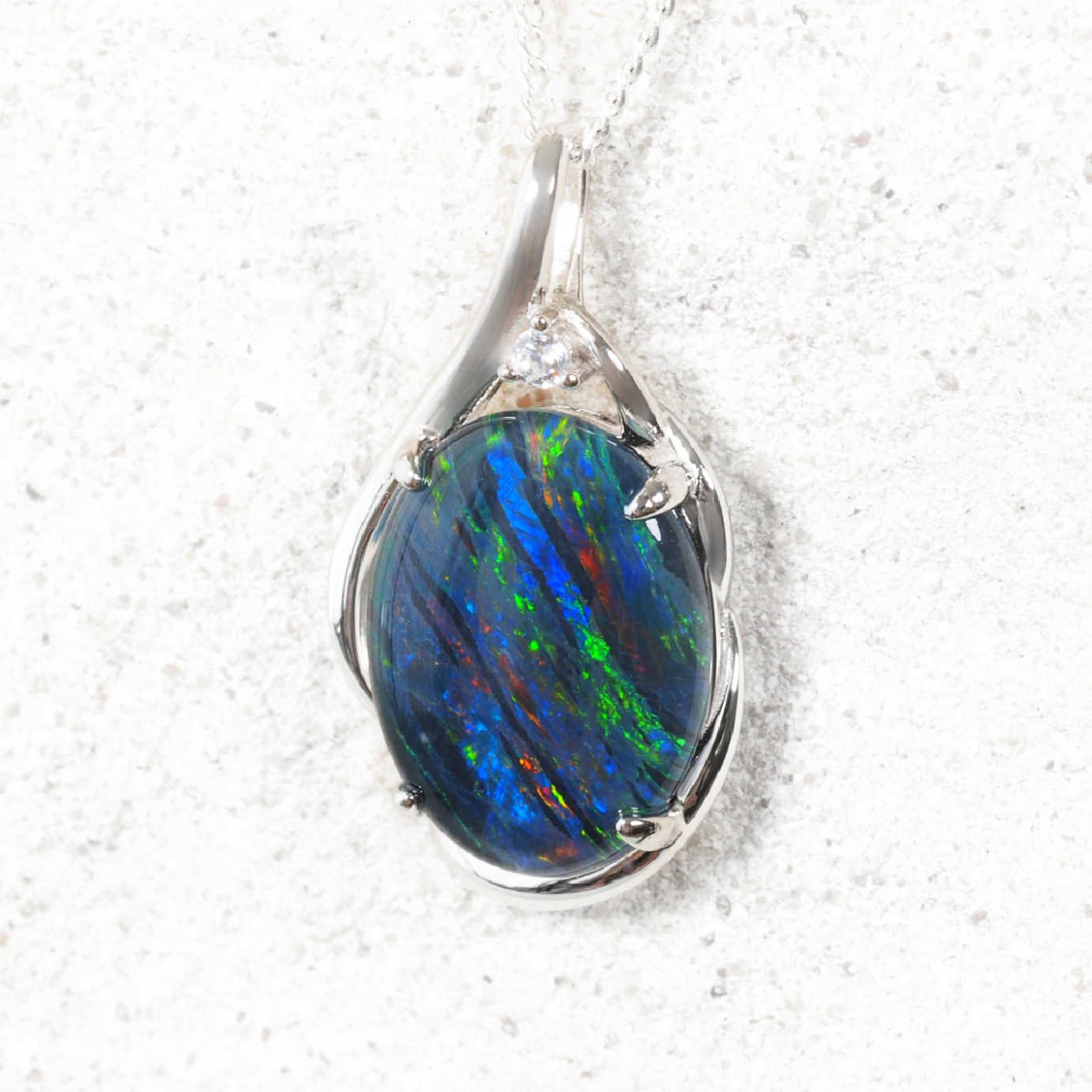 Silver opal pendant on a white background