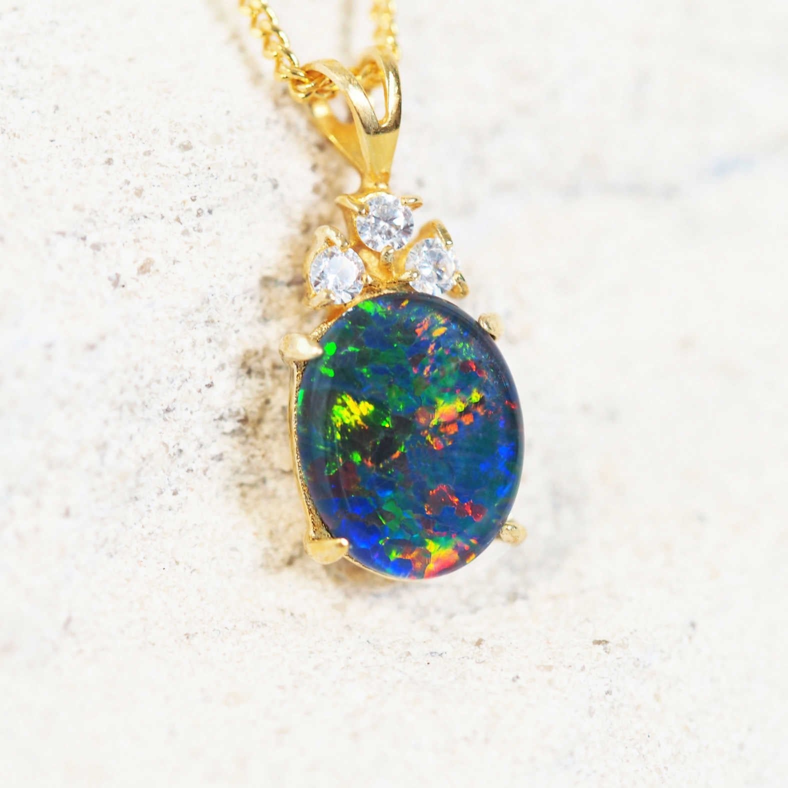 Colourful opal pendant with three sparkling crystals