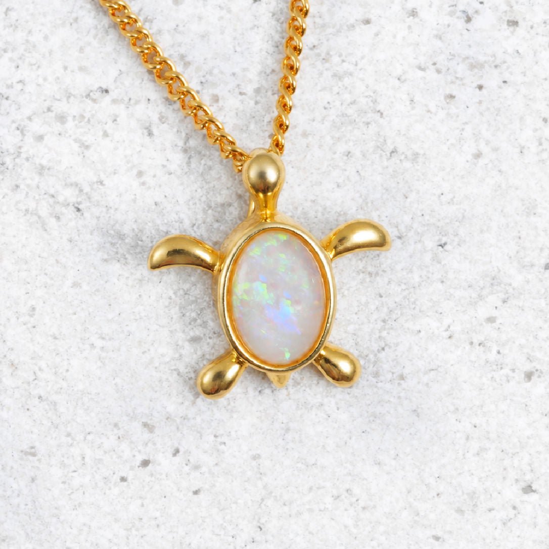 gold plated silver turtle pendant with a crystal opal