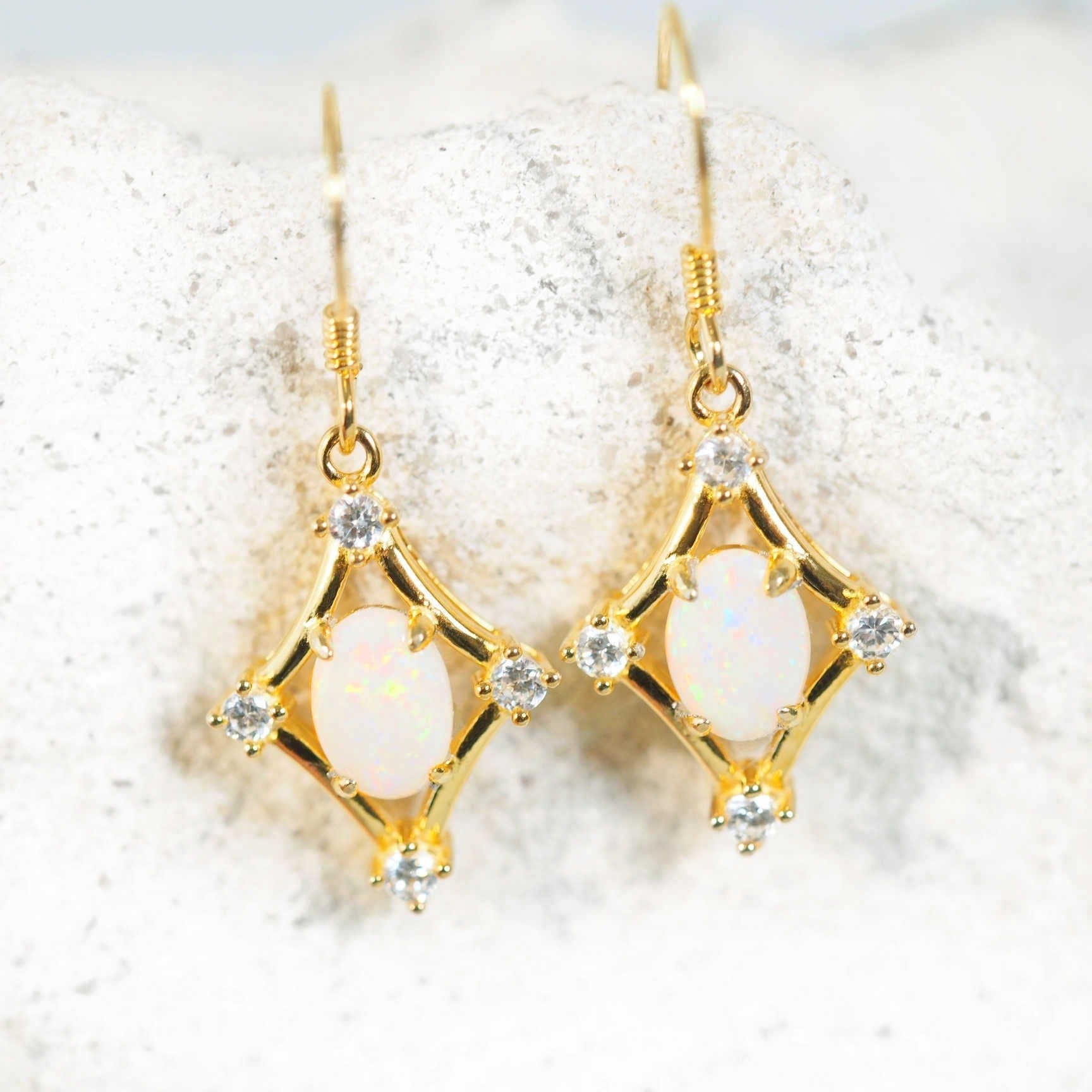 white opal earrings set in gold plated silver