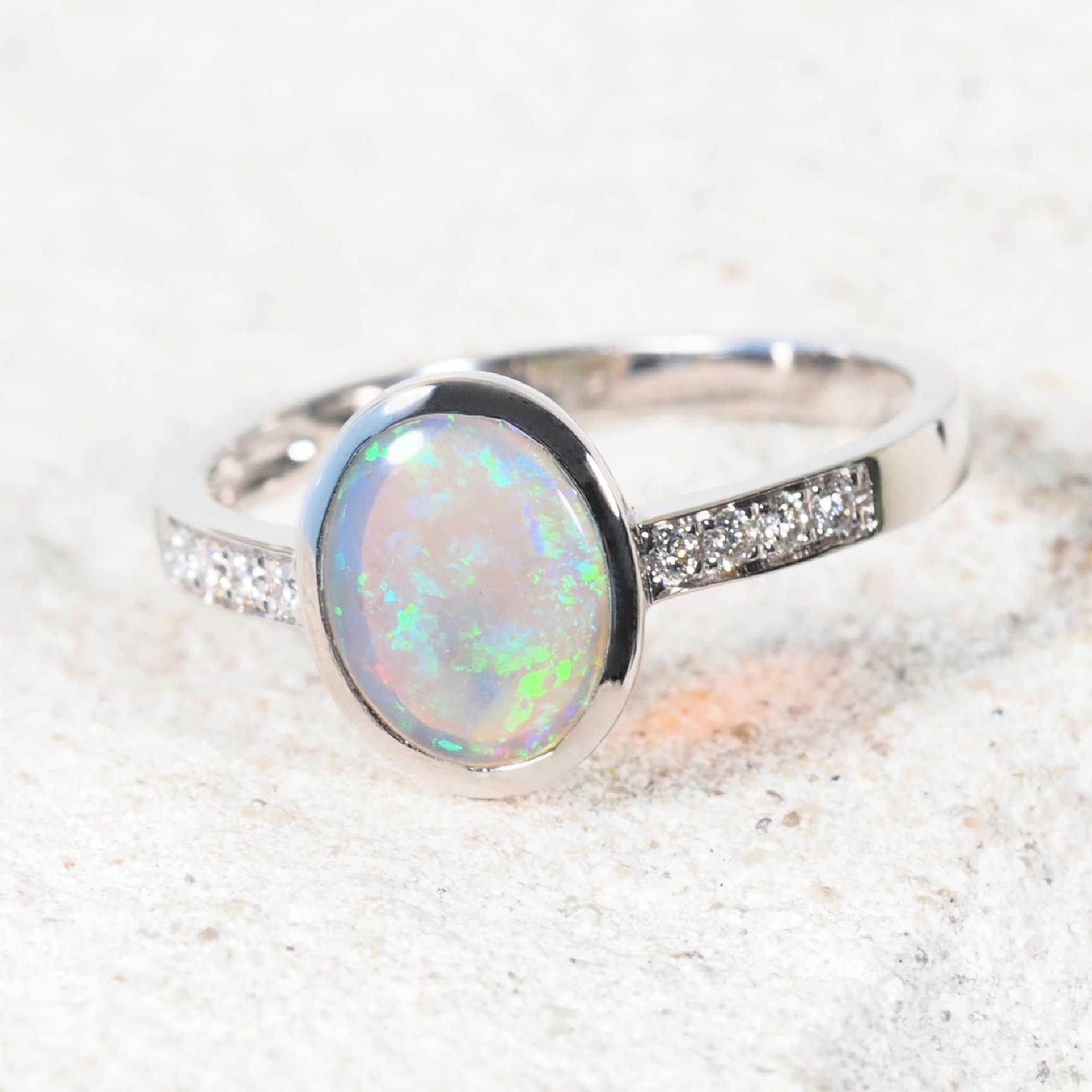 Australian crystal opal ring with subtle sparkle from eight white diamonds