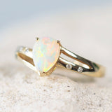 Australian solid crystal opal set into a 14ct gold split band ring wiht four sparkling diamonds