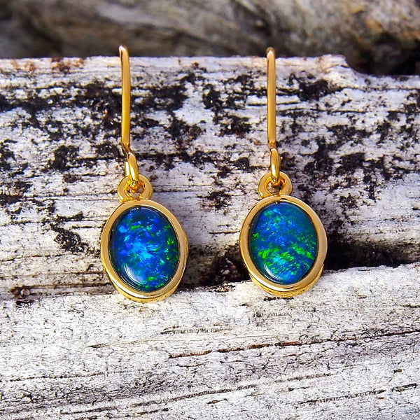 Gold plated sterling silver shepherd hook earrings bezel set with blue and green oval triplet opals.
