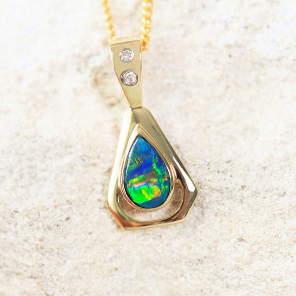 14ct gold doublet opal pendant set with a multi-coloured, teardrop-shaped australian opal and two diamonds