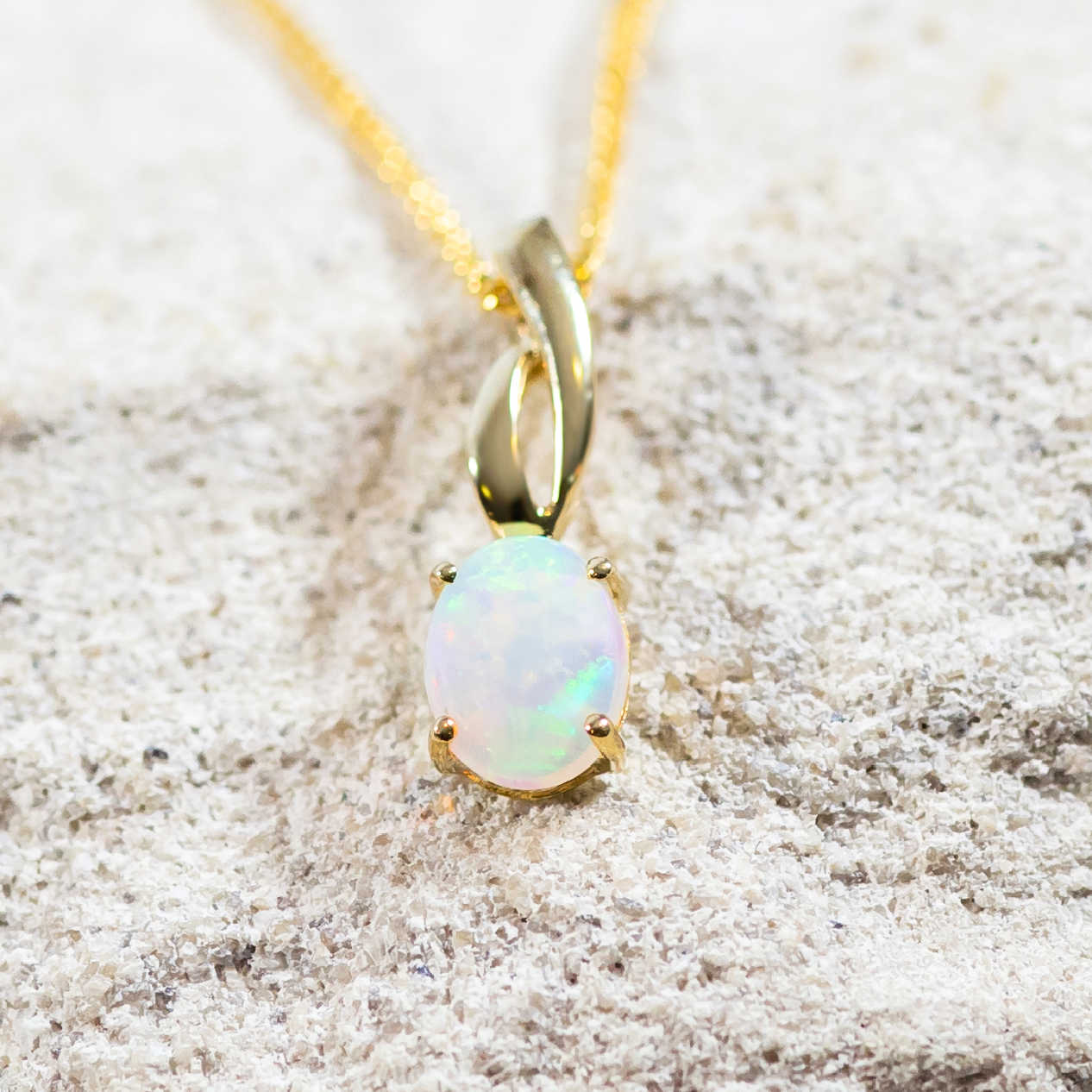 blue and green white opal set into 9ct gold necklace