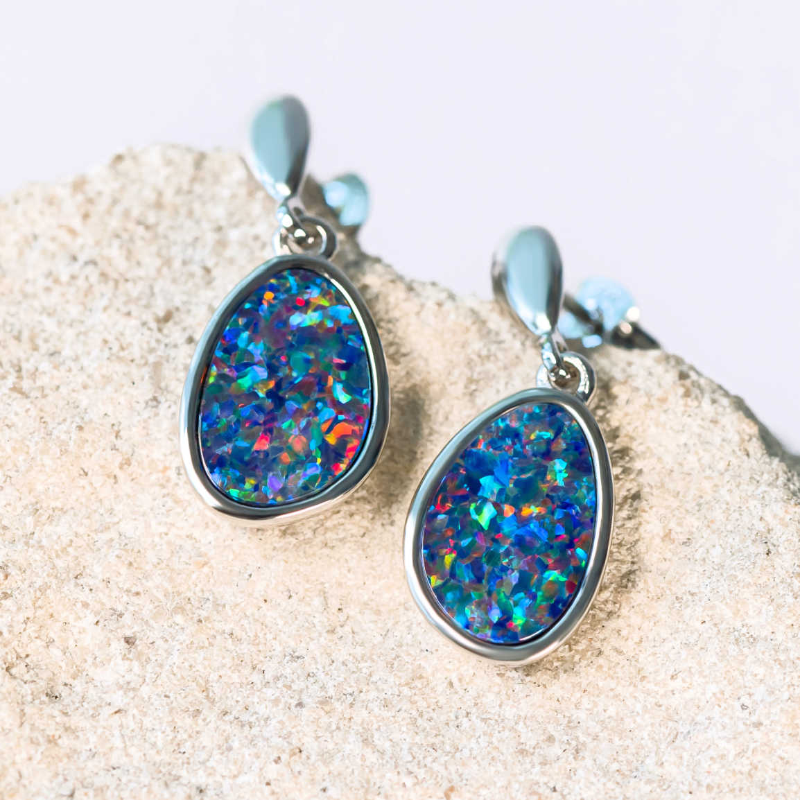 silver drop earrings set with multi-coloured doublet opals