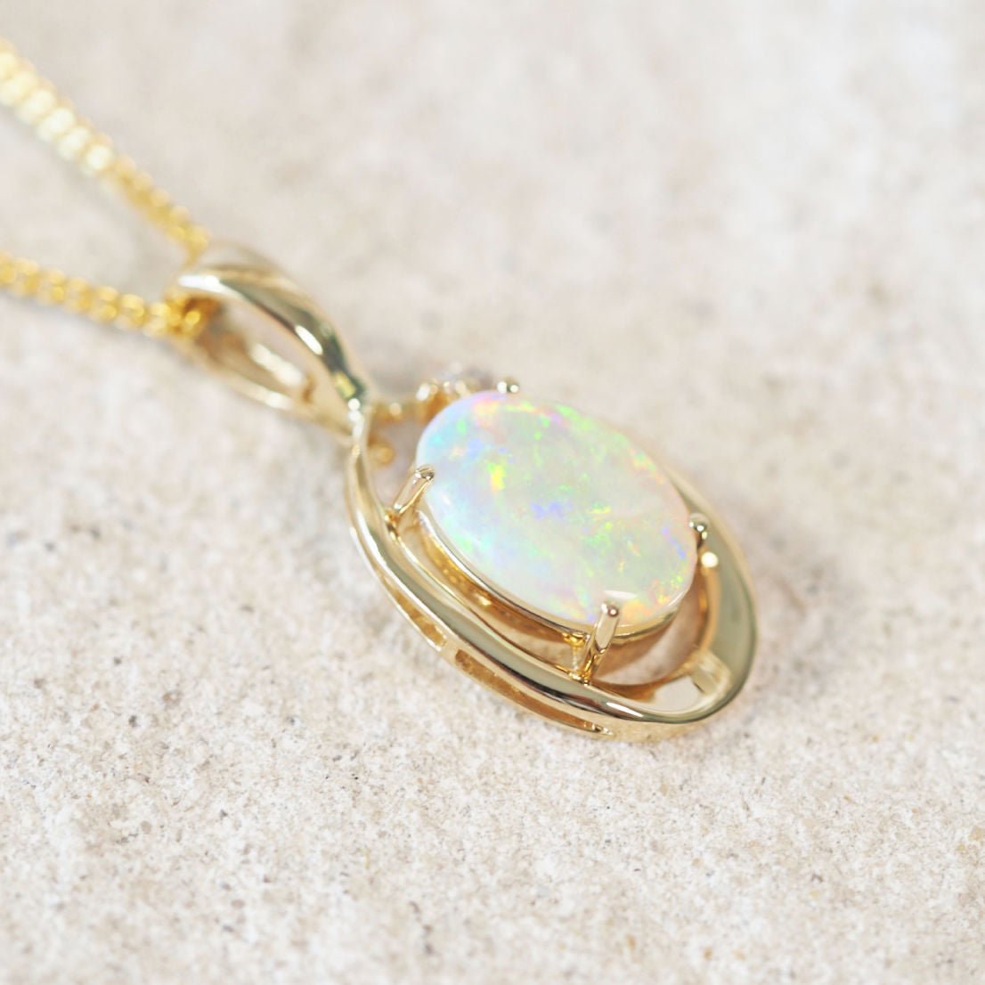 crystal opal pendant in gold with two diamonds