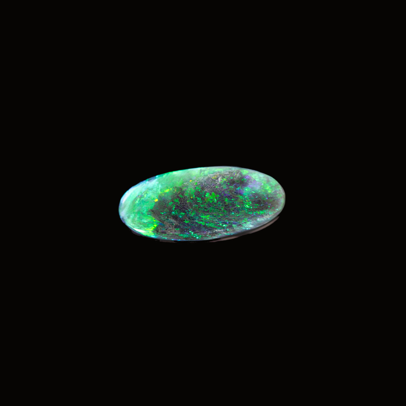 'Emerelle' Lightning Ridge black opal gemstone with vivid green fire on dark charcoal body tone