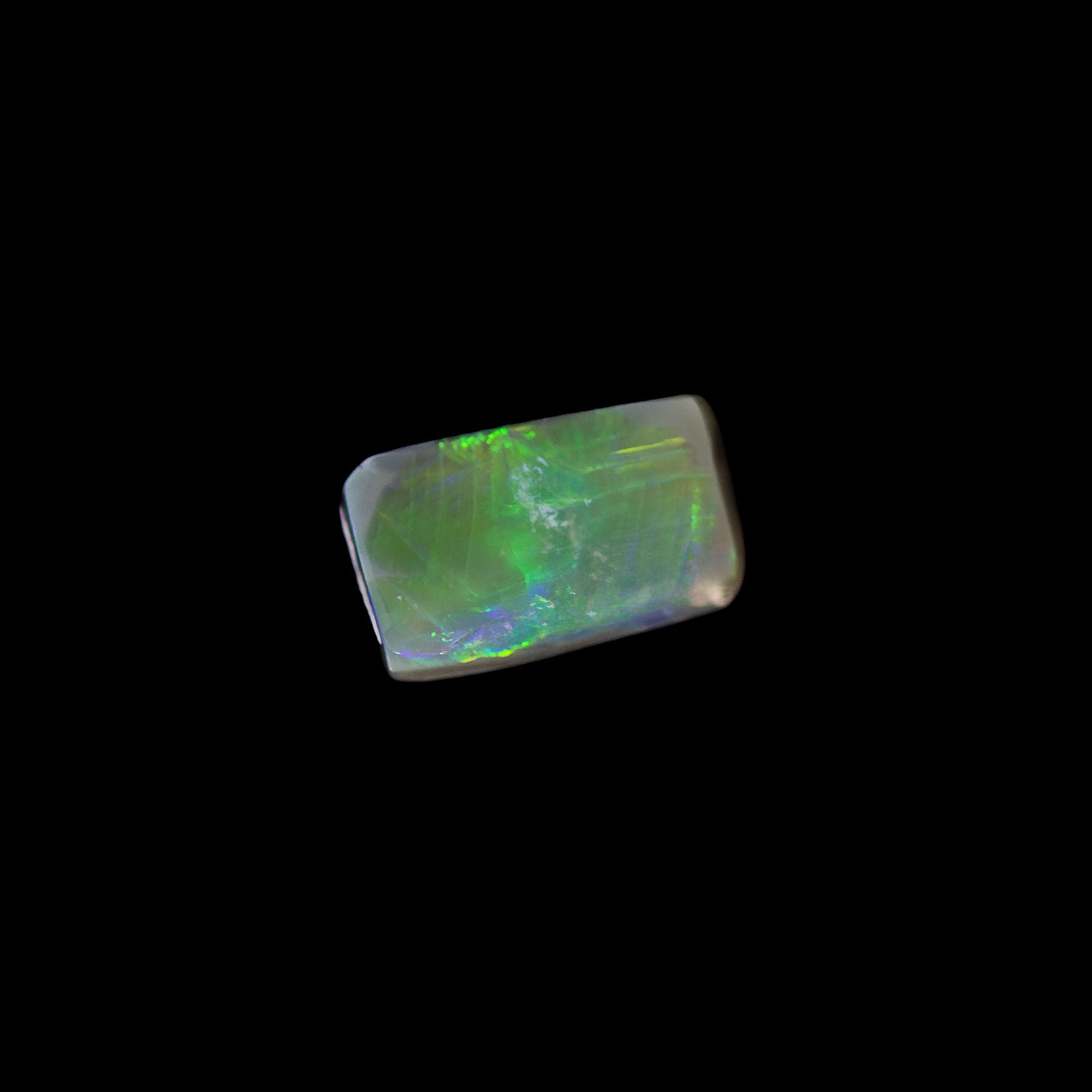 Selvya rectangular semi-black opal from Lightning Ridge with vivid green fire on dark body tone
