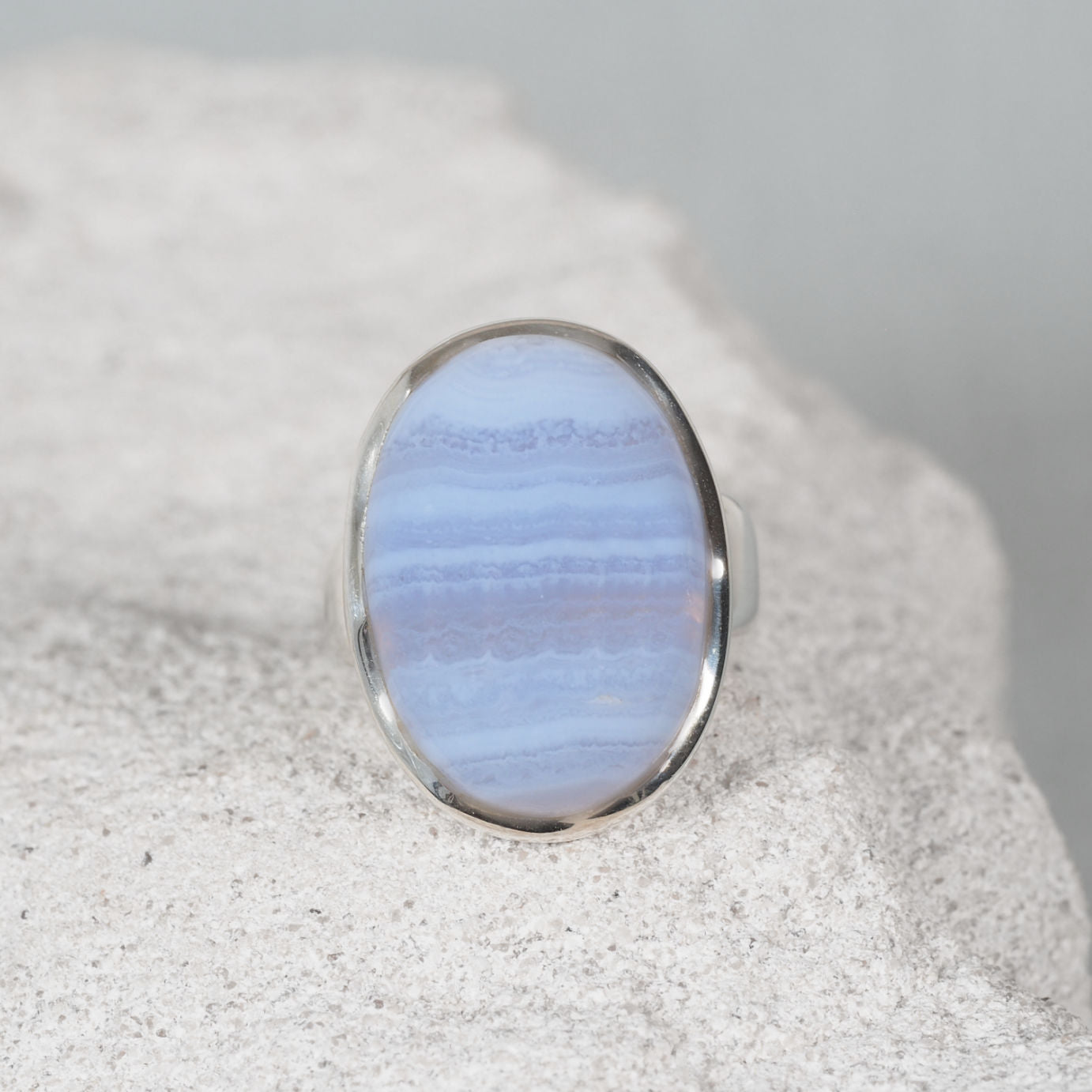 Elegant silver ring, ‘Vivianne,’ showcasing a polished oval Blue Lace Agate gemstone with natural flowing stripes