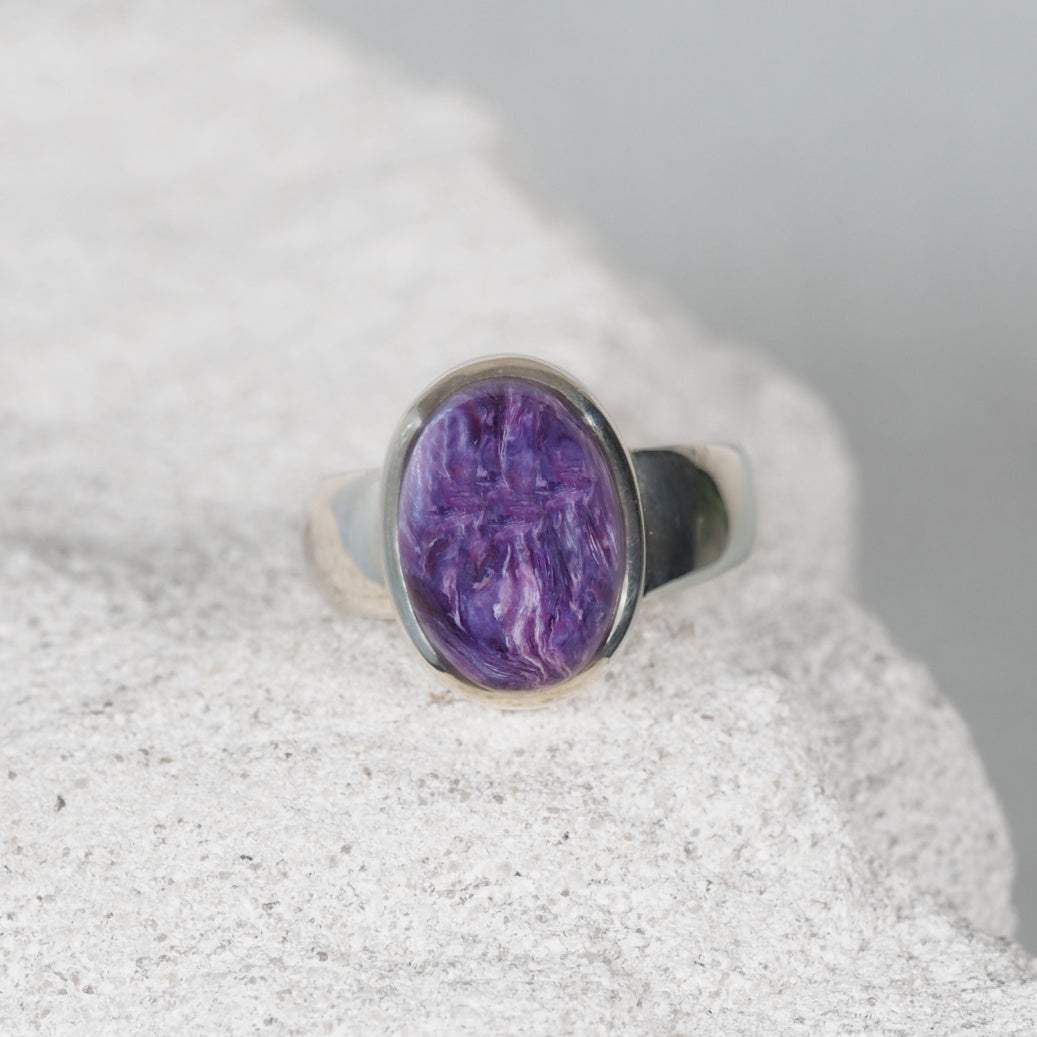 Charoite Gemstone ring displaying deep purple swirls in a silver frame