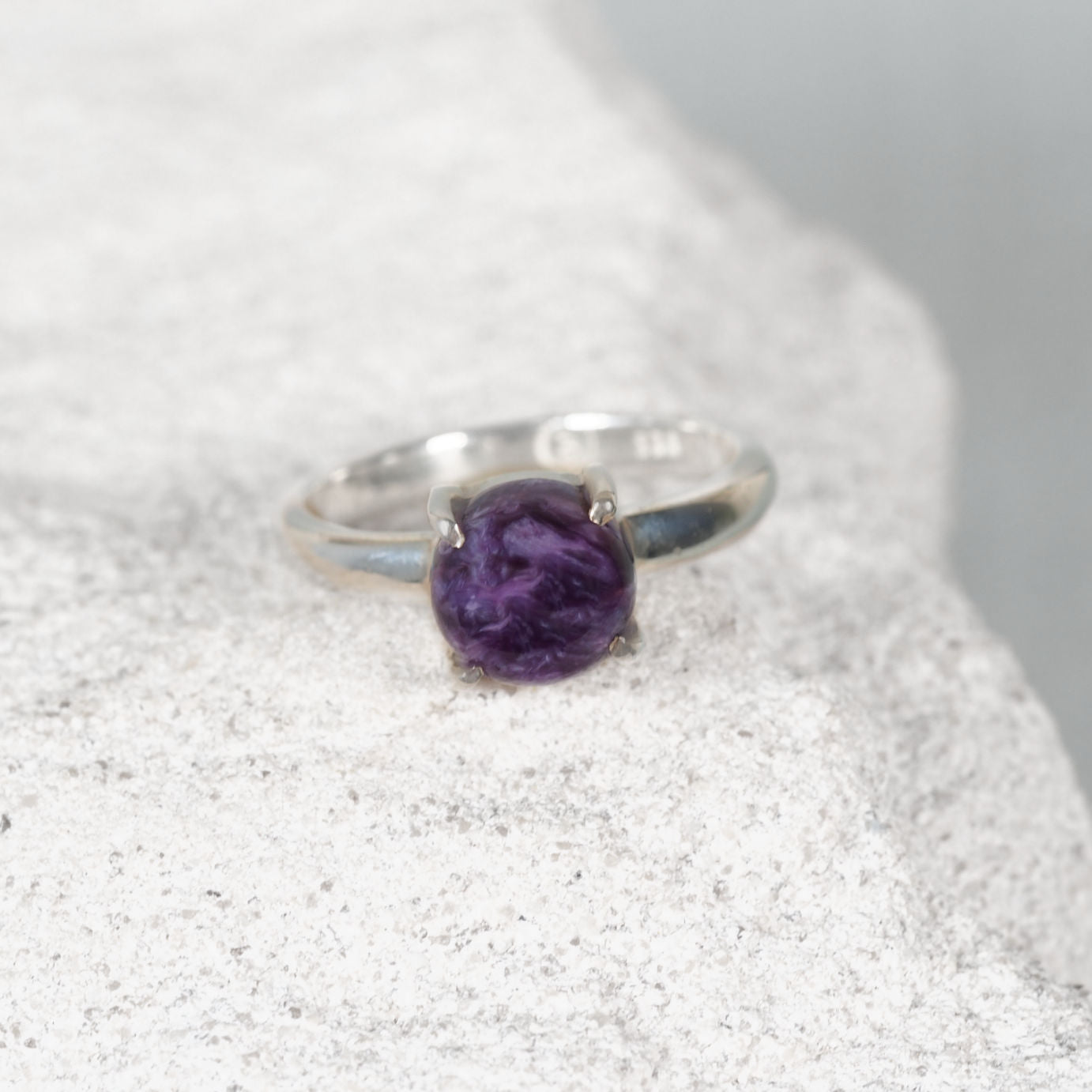 Small silver Charoite ring featuring a round purple gemstone with delicate white and lavender marbling