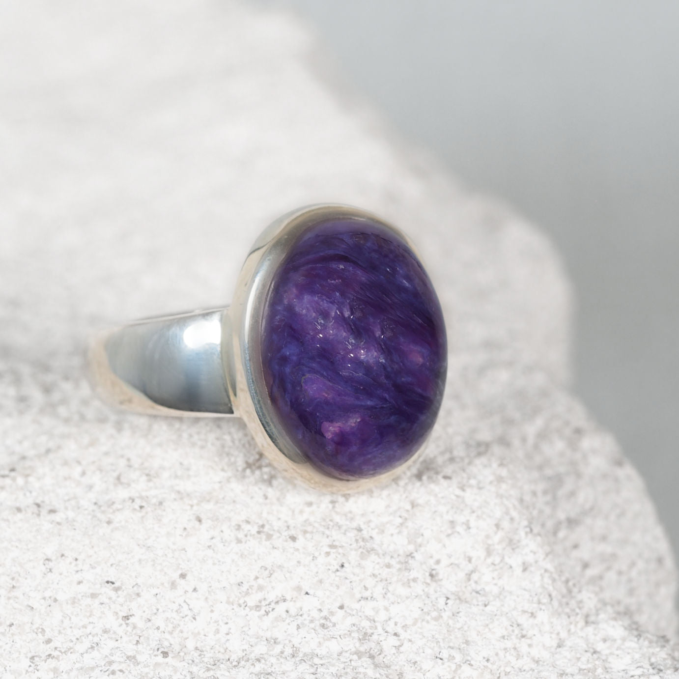 Round Charoite silver ring showcasing deep purple hues with gentle marbled patterns, elegant and minimalist design