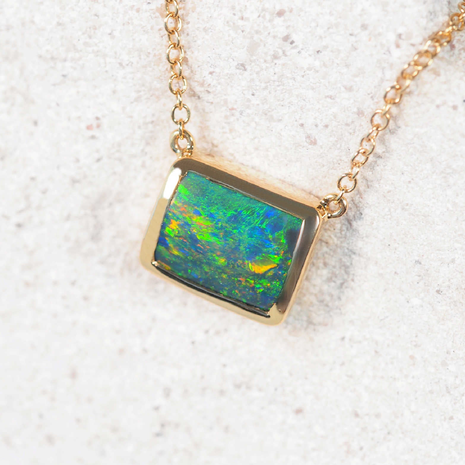 Rectangular black opal necklet with bezel-set Lightning Ridge gemstone and diamond detailing in solid 14ct yellow gold