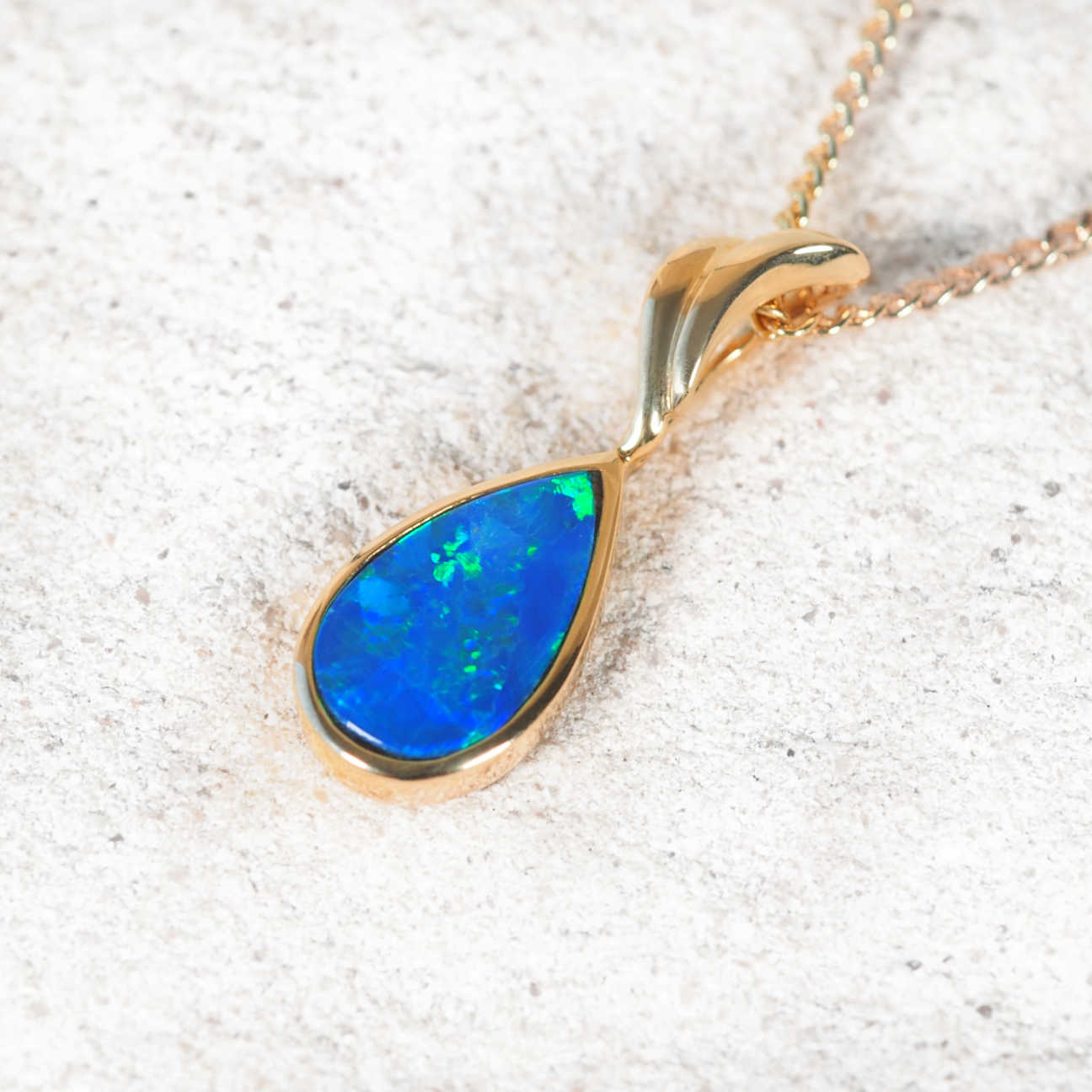 Australian opal pendant in 14ct gold showing vibrant flashes of blue and green