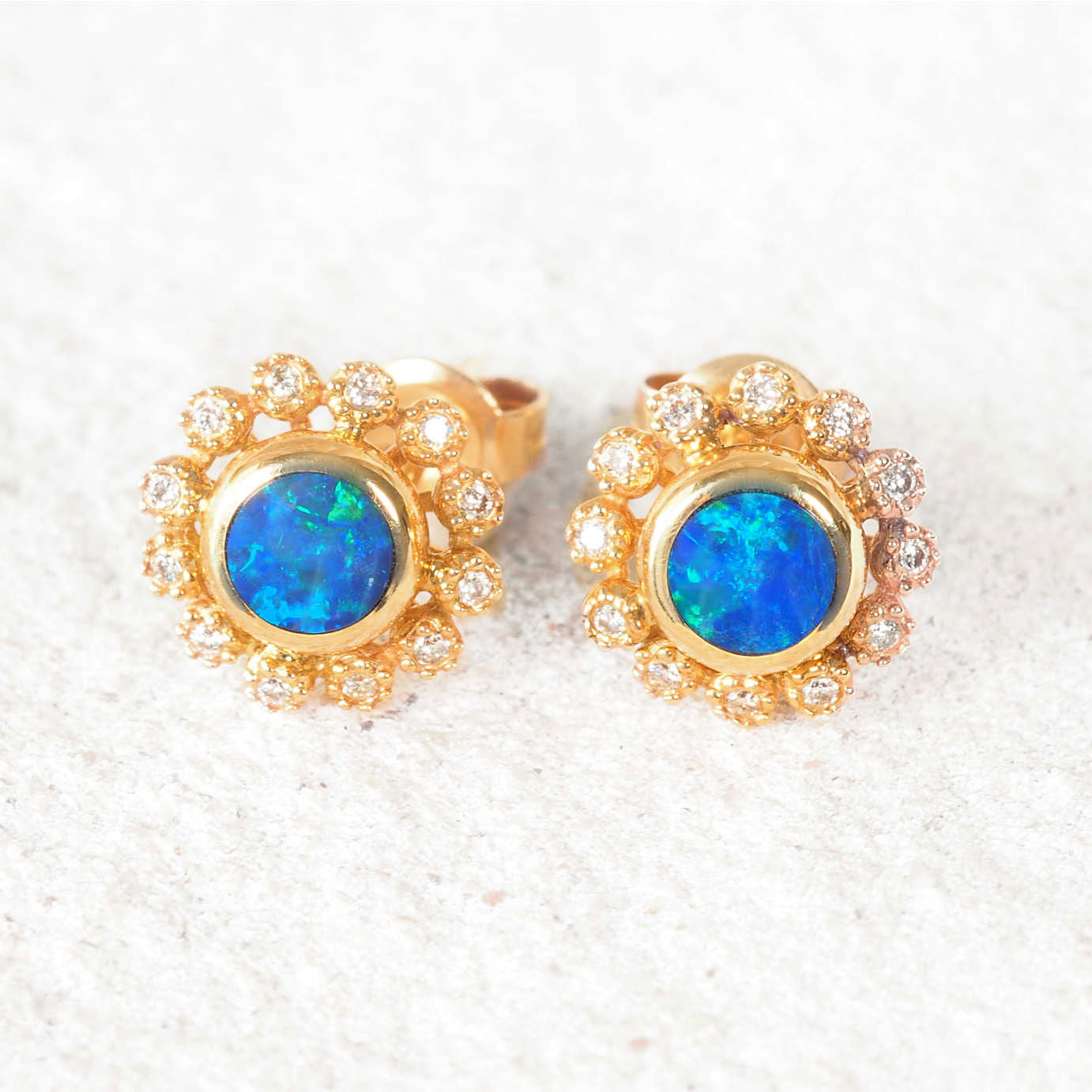 14ct yellow gold stud opal earrings with round blue-green Australian doublet opals and diamond halo