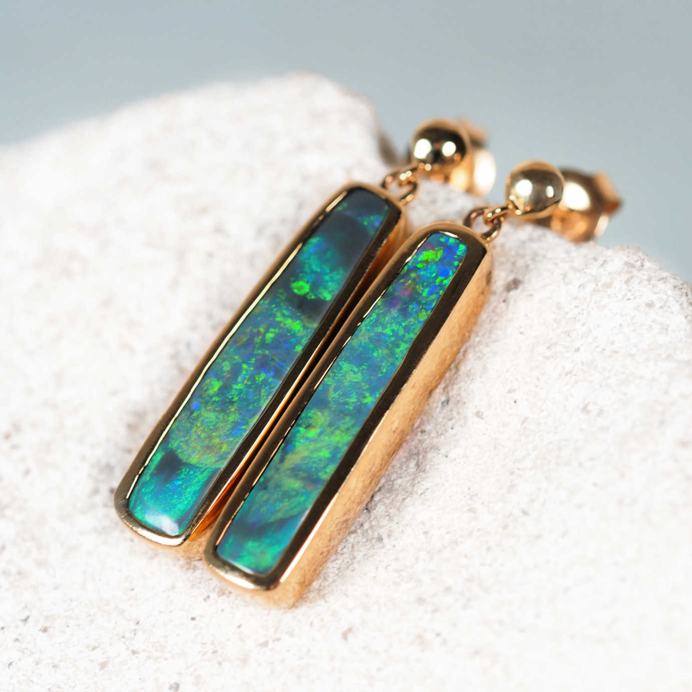 Elegant 14ct yellow gold rectangular black opal studs with bright green and blue tones – Margareta design