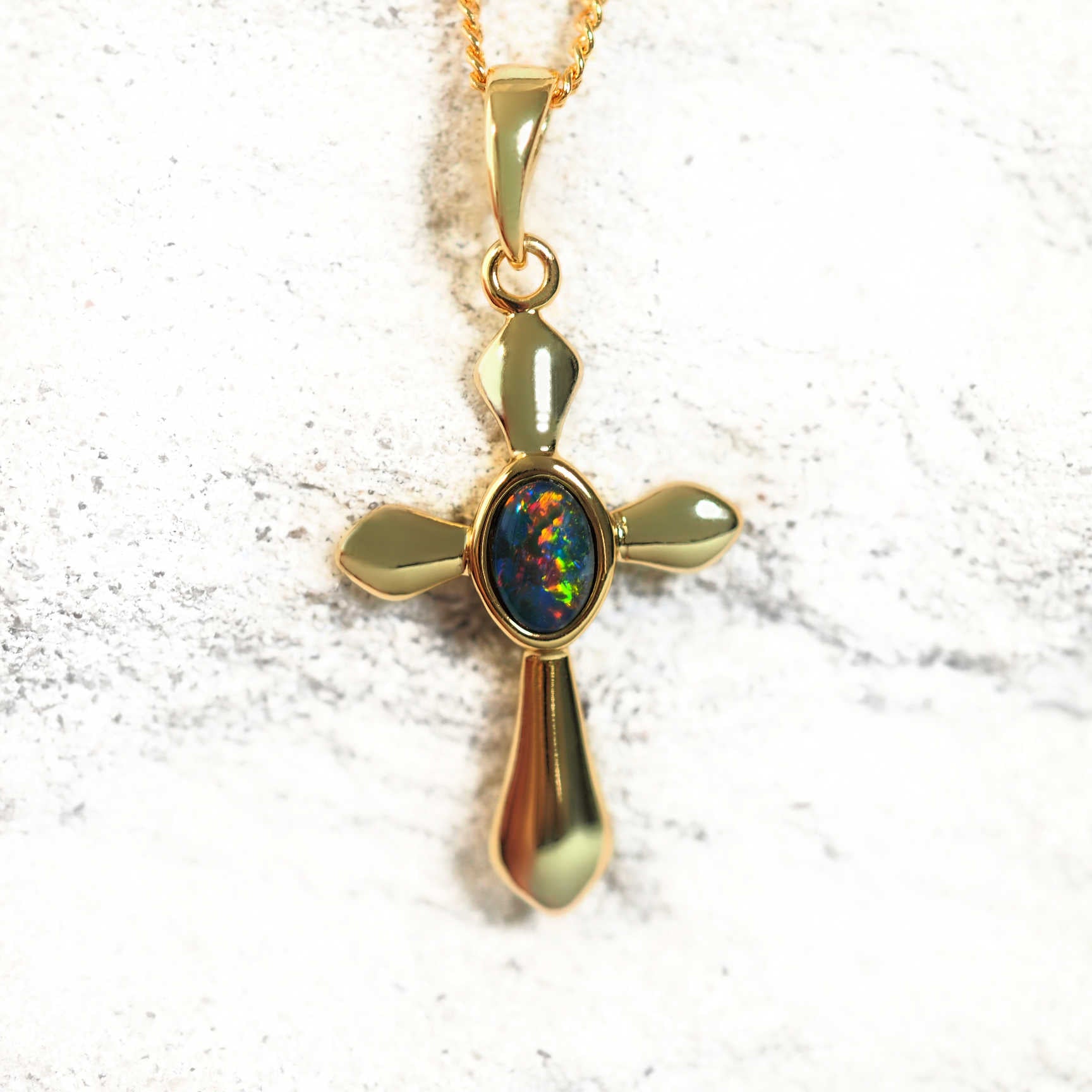 gold plated silver opal pendant in a cross design