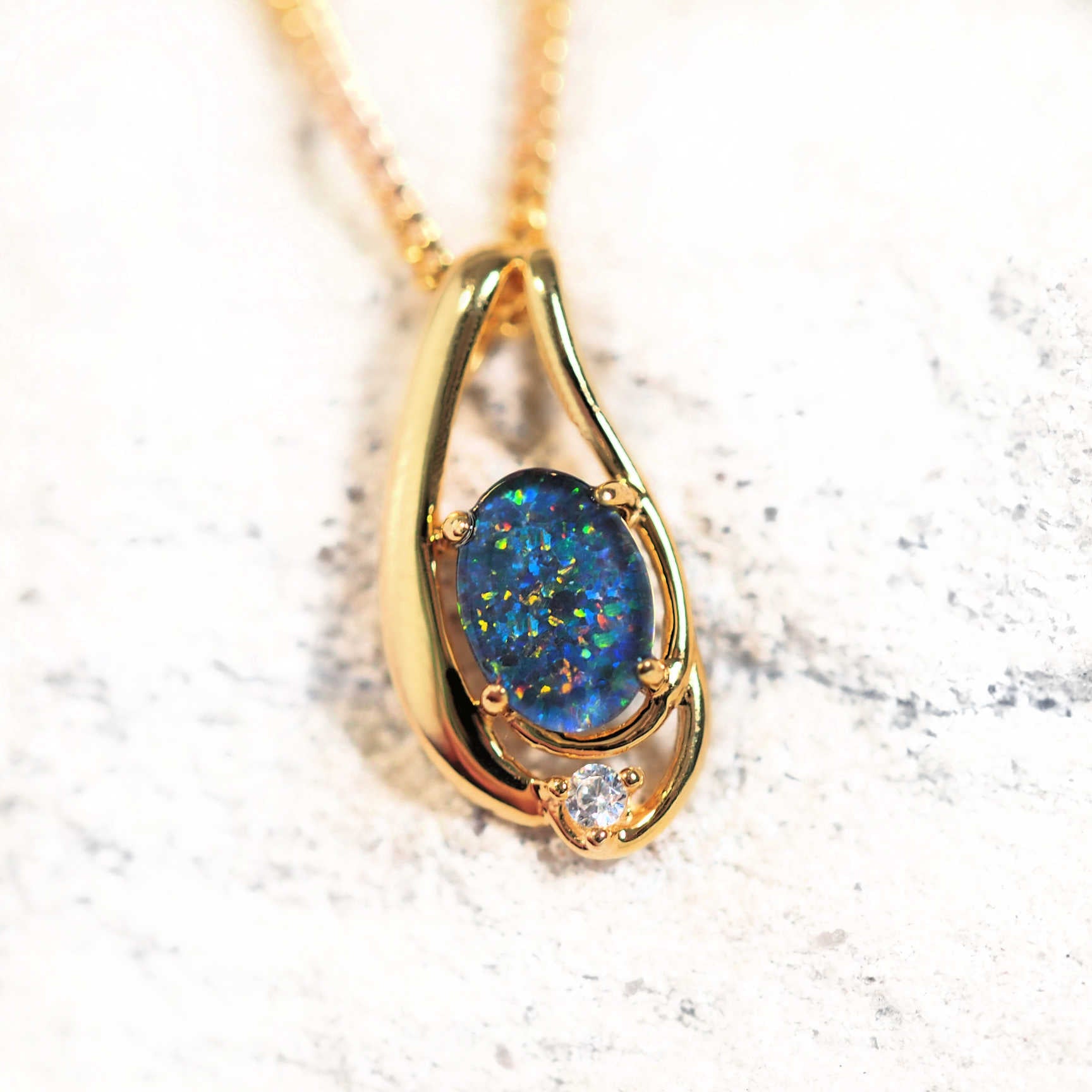 Gold-plated silver opal pendant necklace with claw-set multi-coloured Australian triplet opal and one cubic zirconia, shown with matching chain.