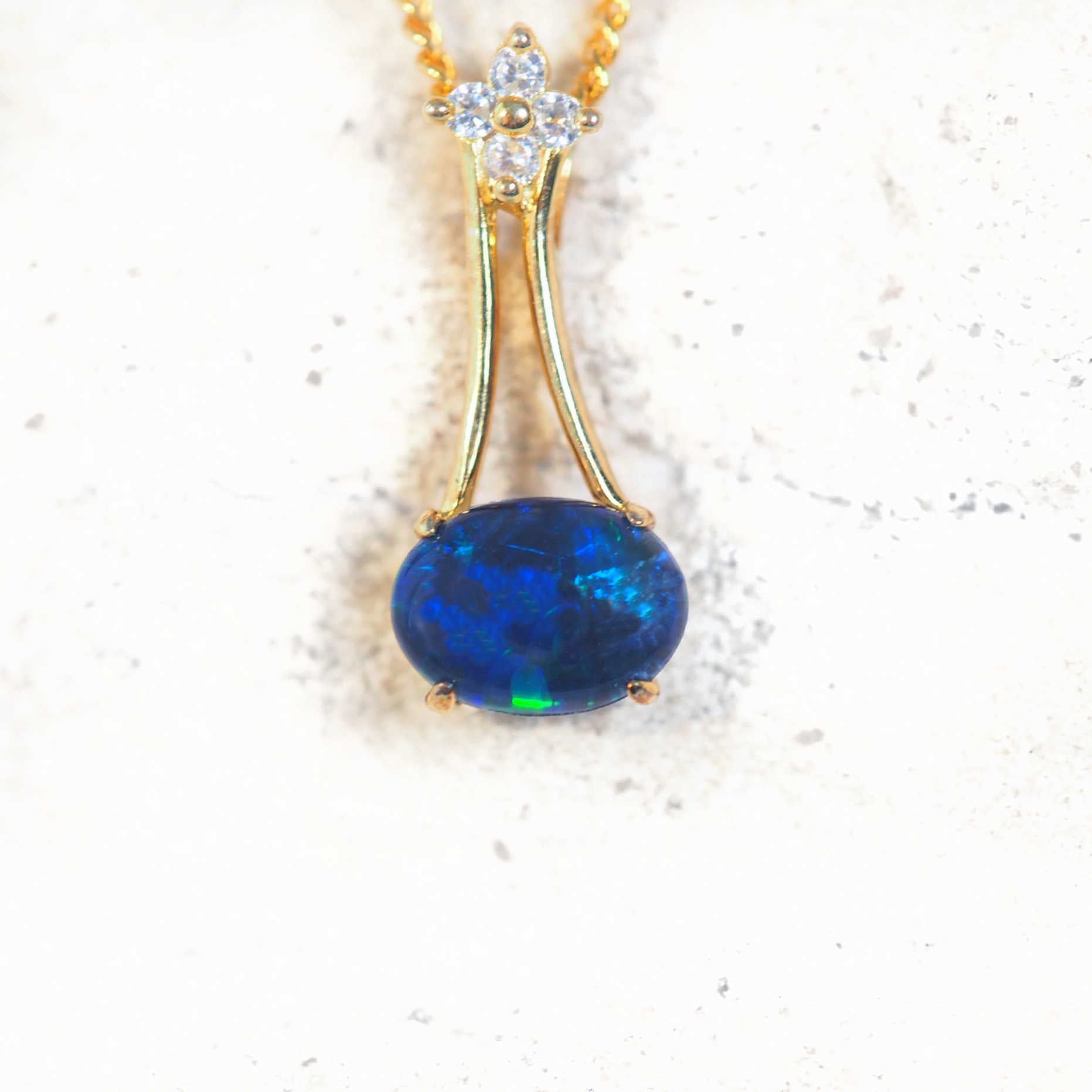 Gold-plated silver opal pendant necklace with sideways-set Australian triplet opal and cubic zirconia flower design